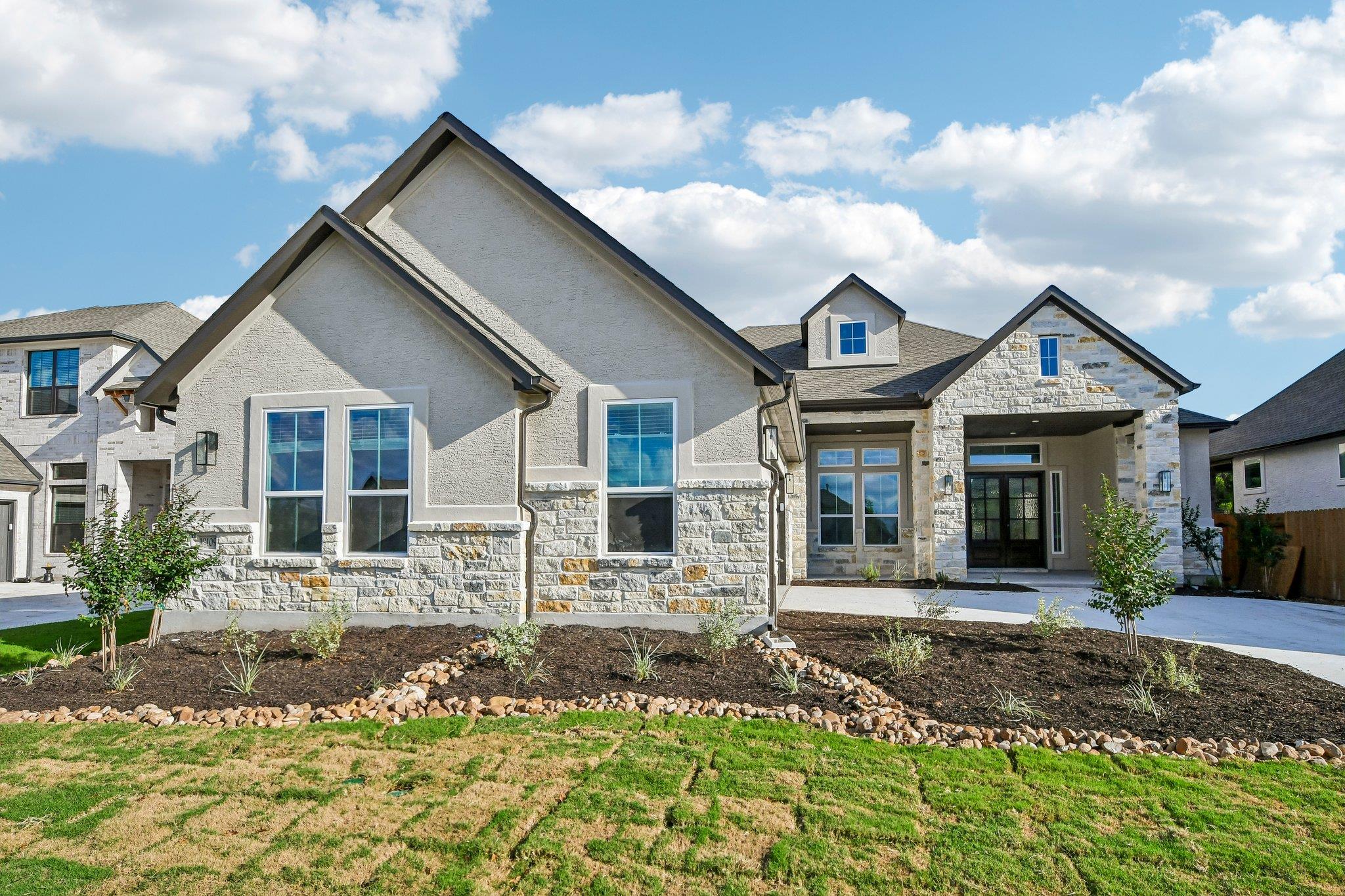 Modern stone and stucco facade, complemented by m