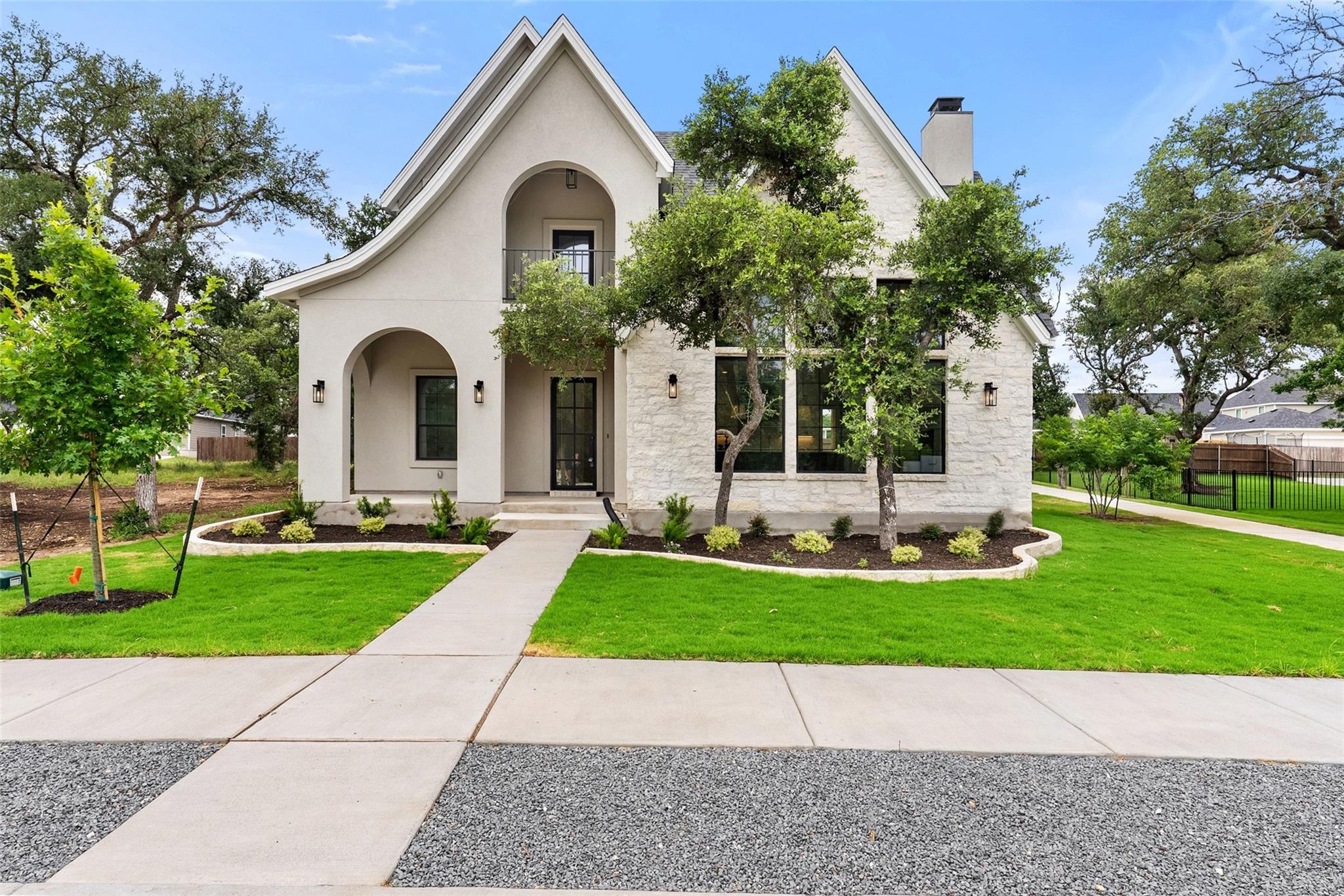 A graceful facade of stucco and stone invites you