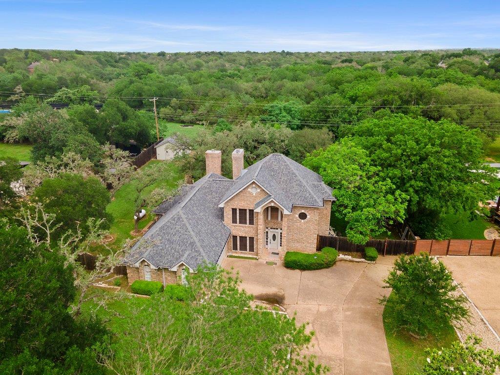 Brick exterior residence featuring a multi-gabled