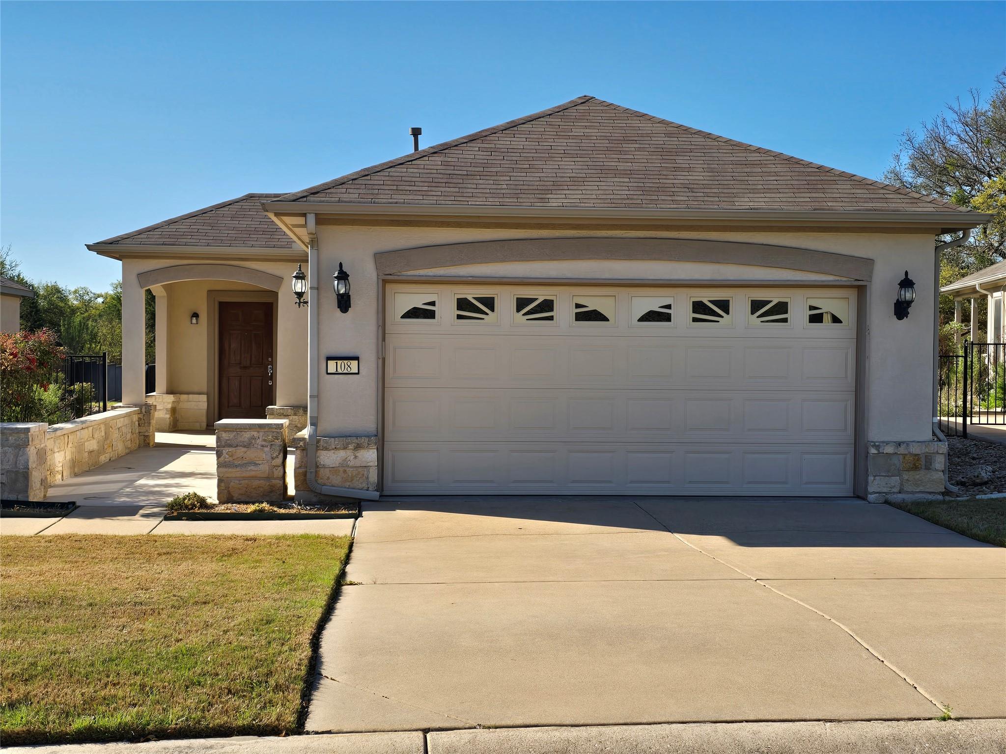 Single story home with an attached garage, concre