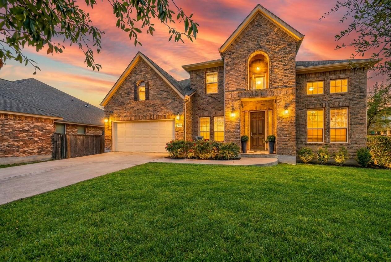 An inviting stone exterior with a garage and a we