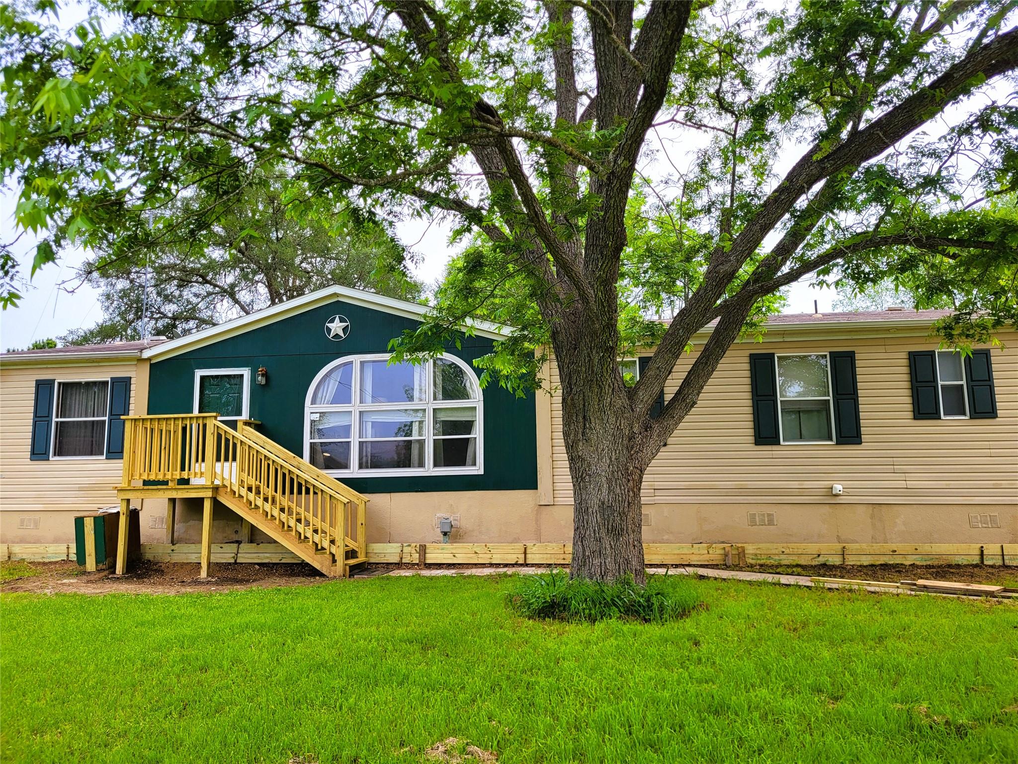 Exterior featuring a deep green gable accent and 