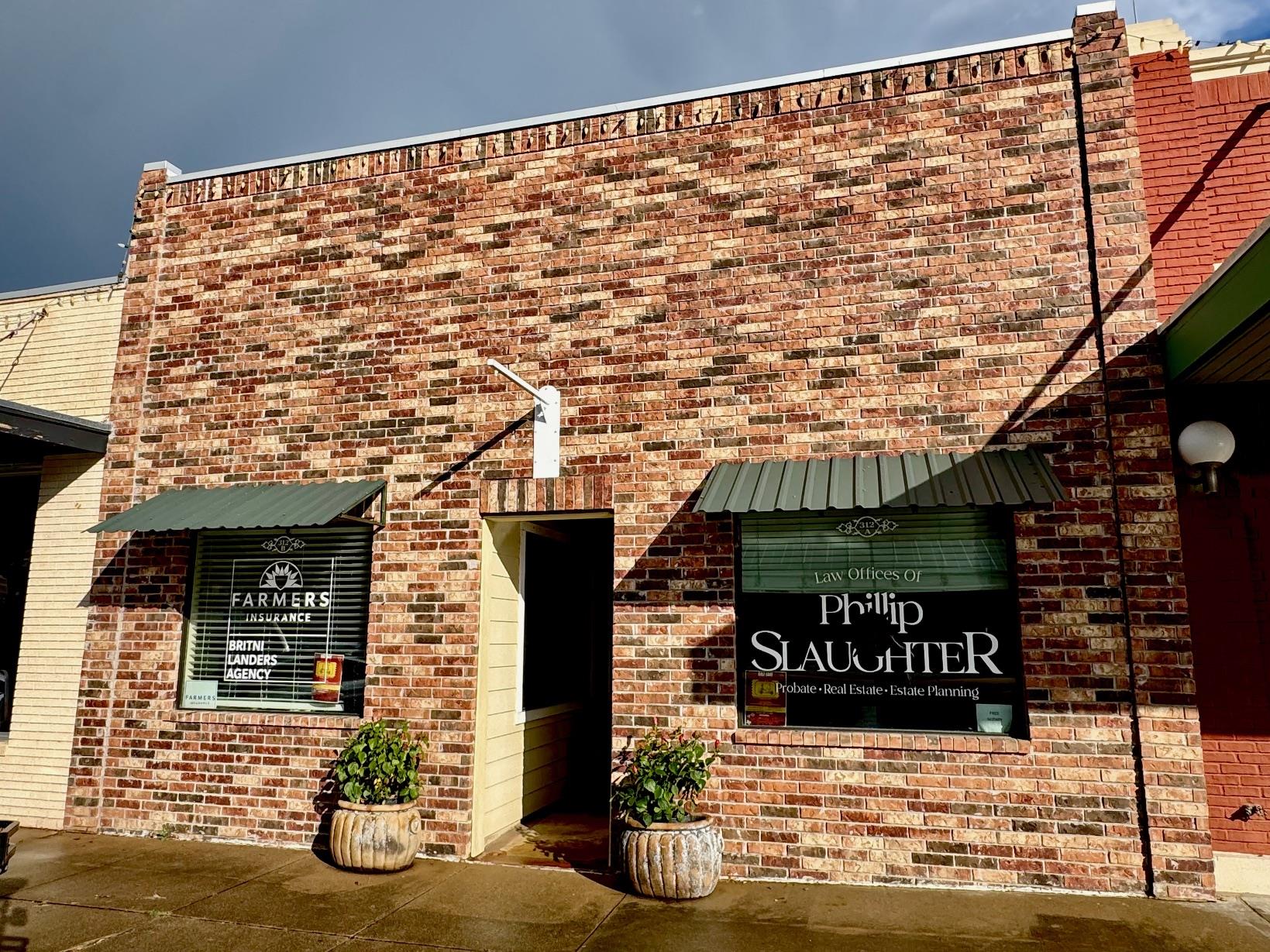 Property entrance featuring brick siding