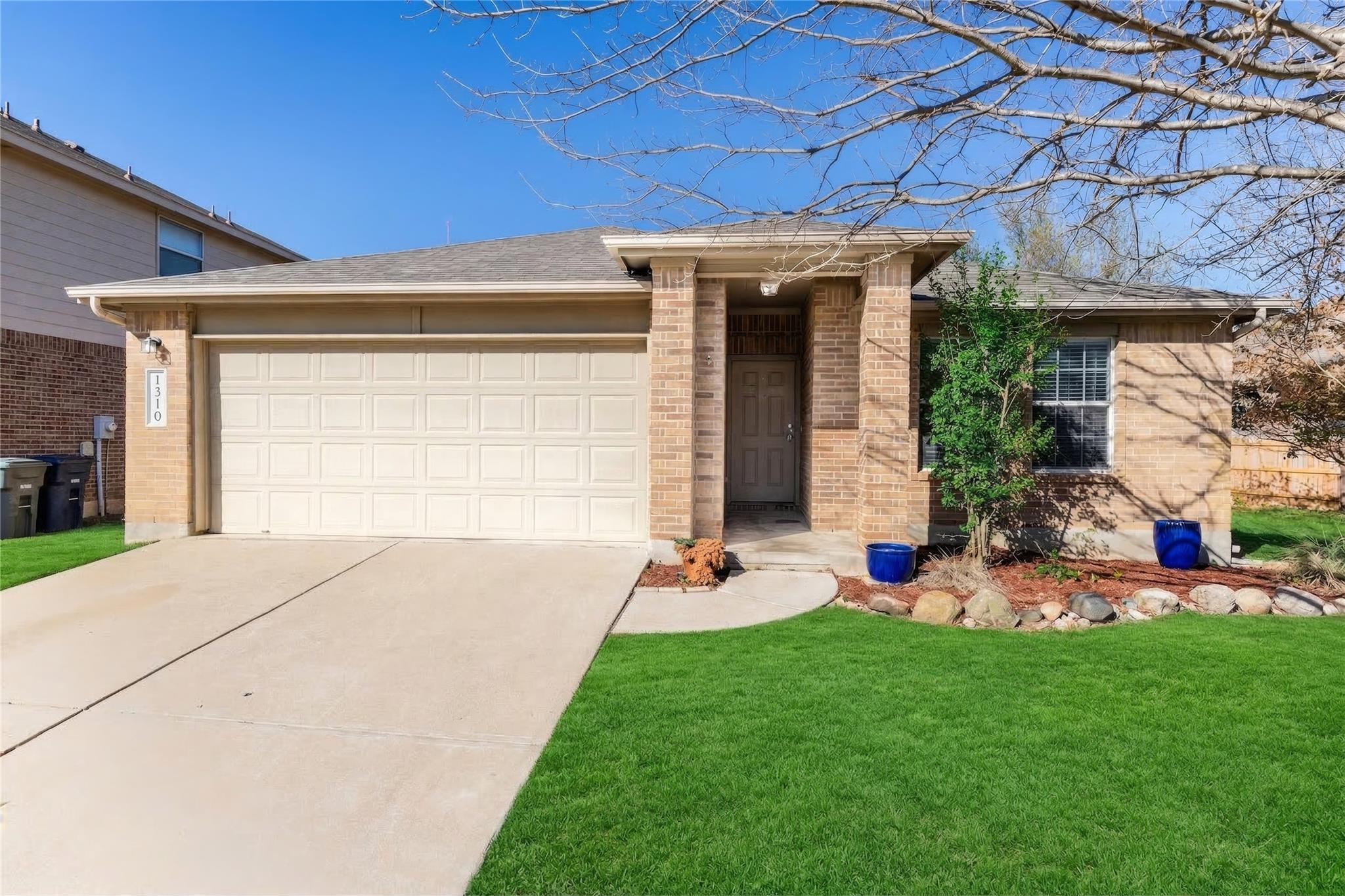 Ranch-style home featuring an attached garage, br