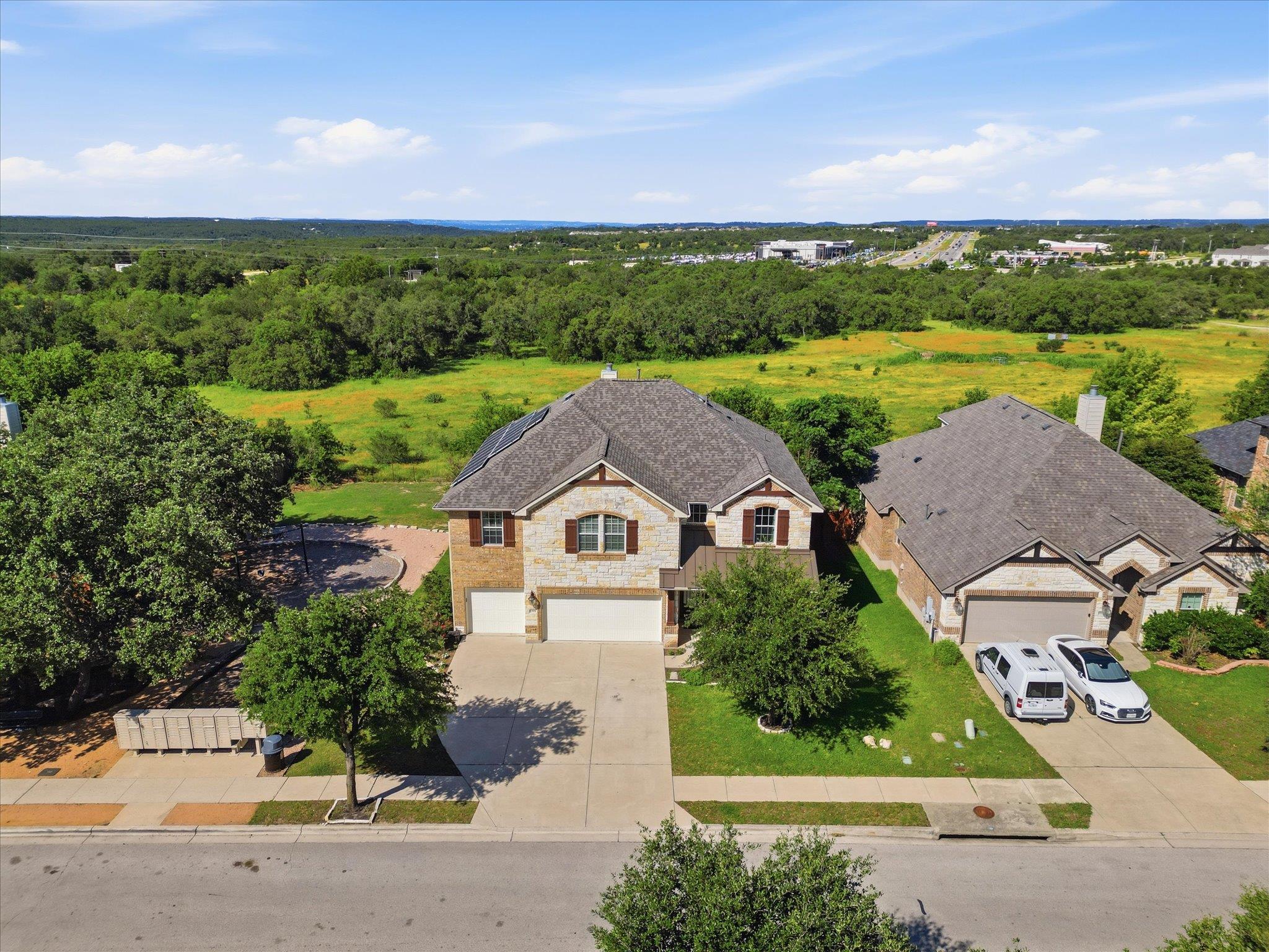 Stone and brick facade home with attached garages