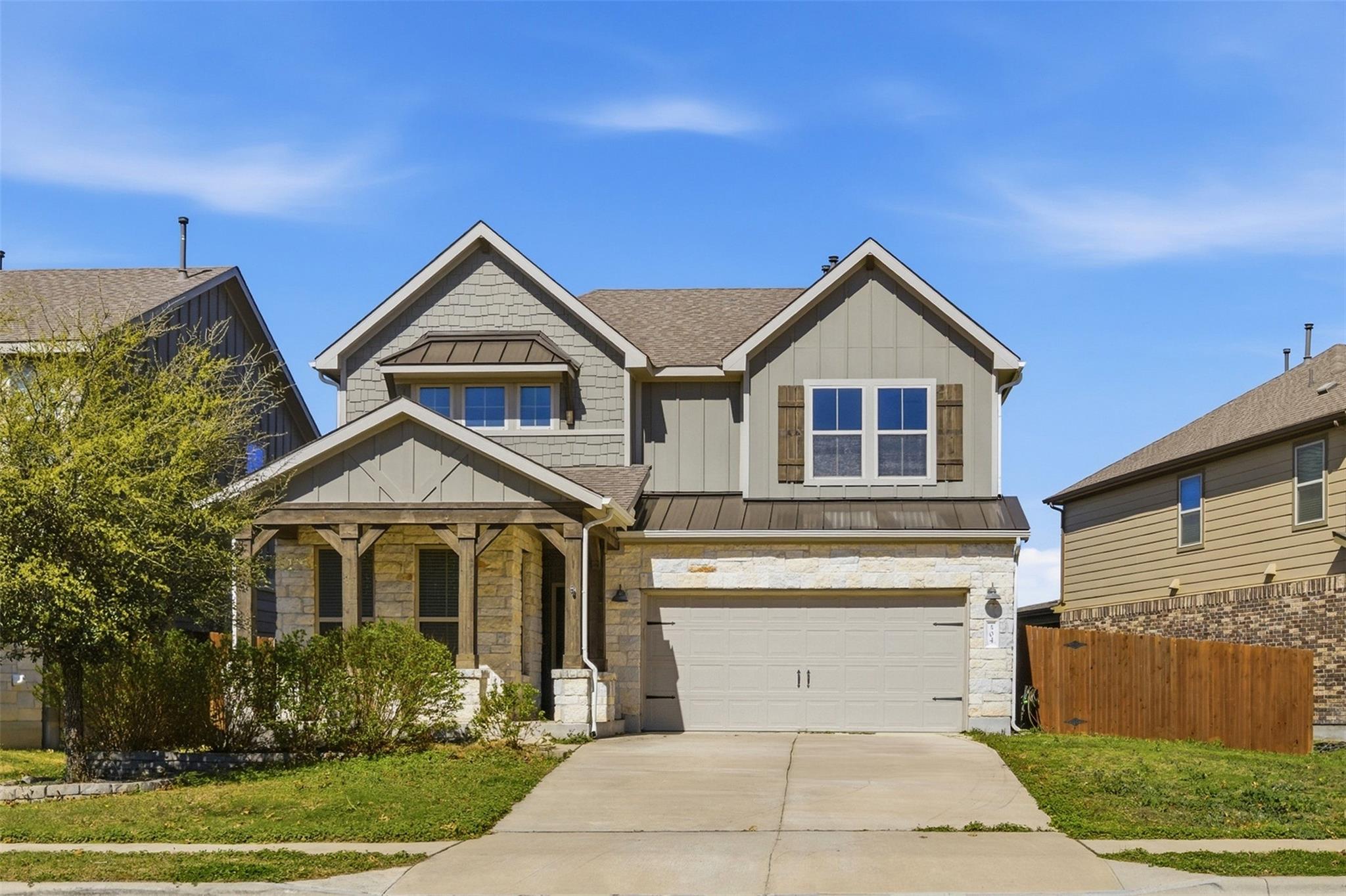 Craftsman-style house with stone siding, board an