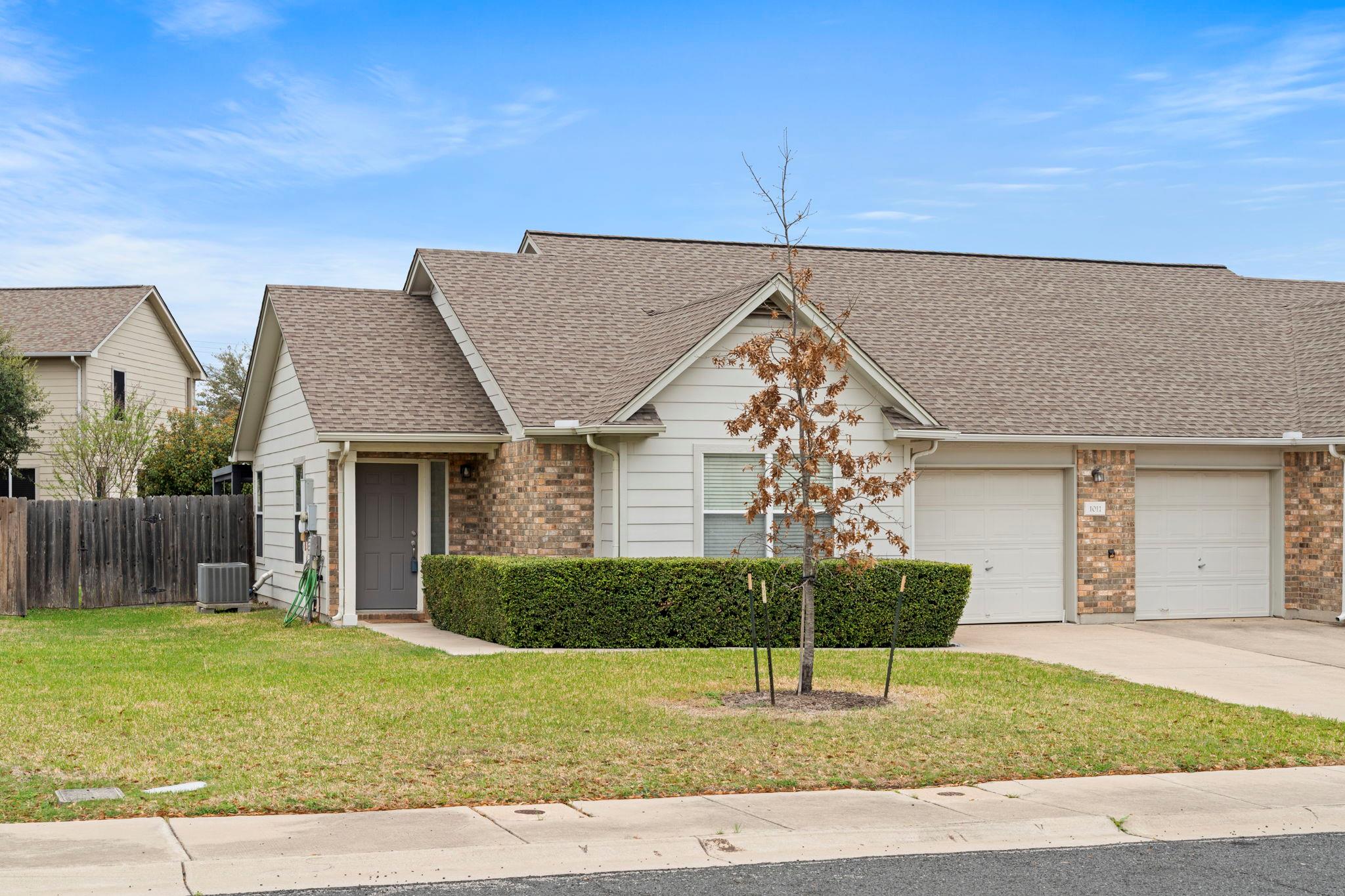 View of front of property featuring roof with shi