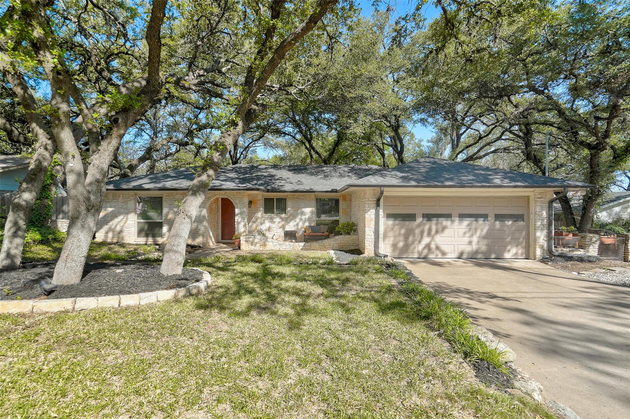 Ranch-style home with an attached garage, concret