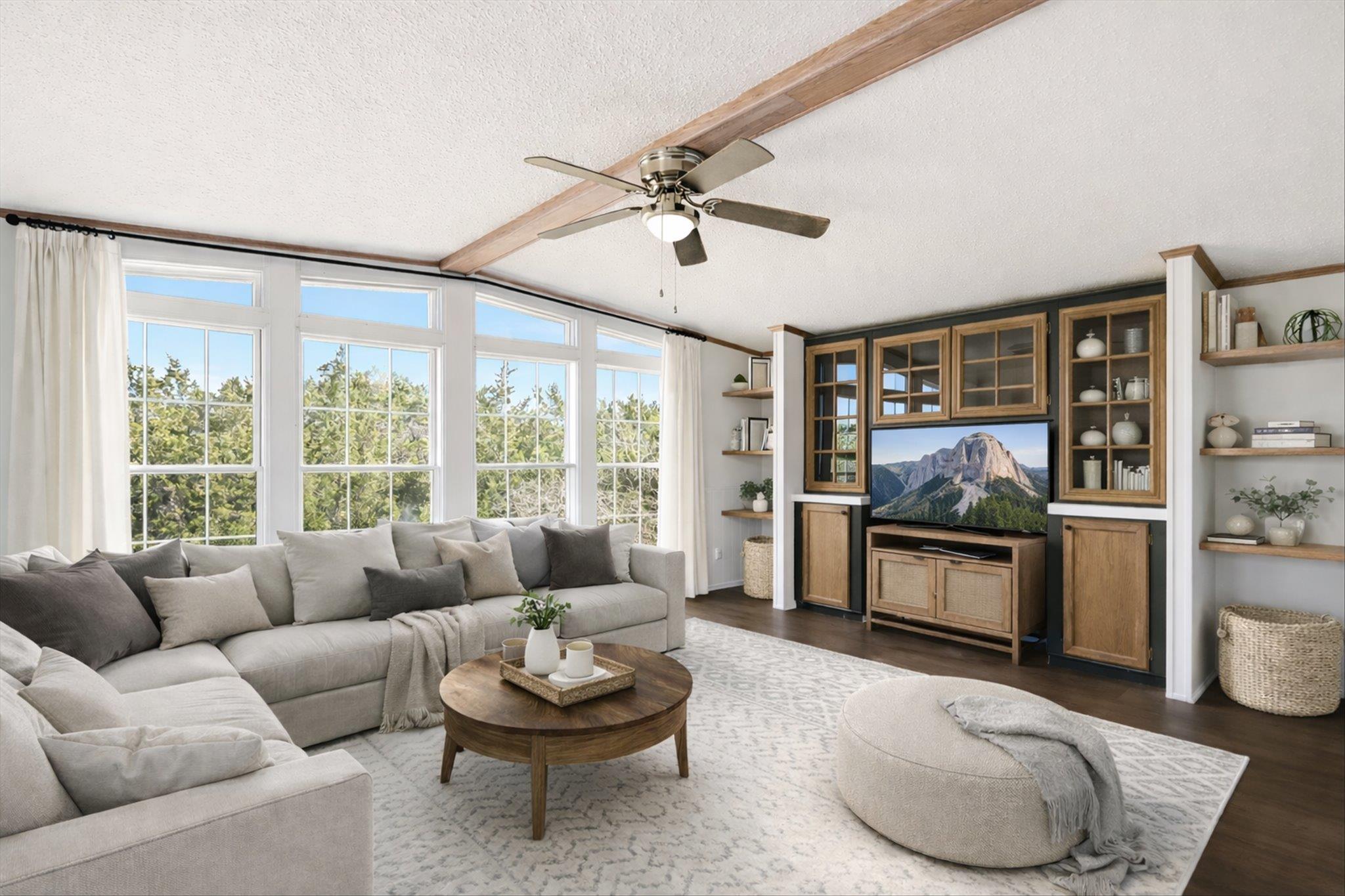 Living room with beamed ceiling, ceiling fan, and
