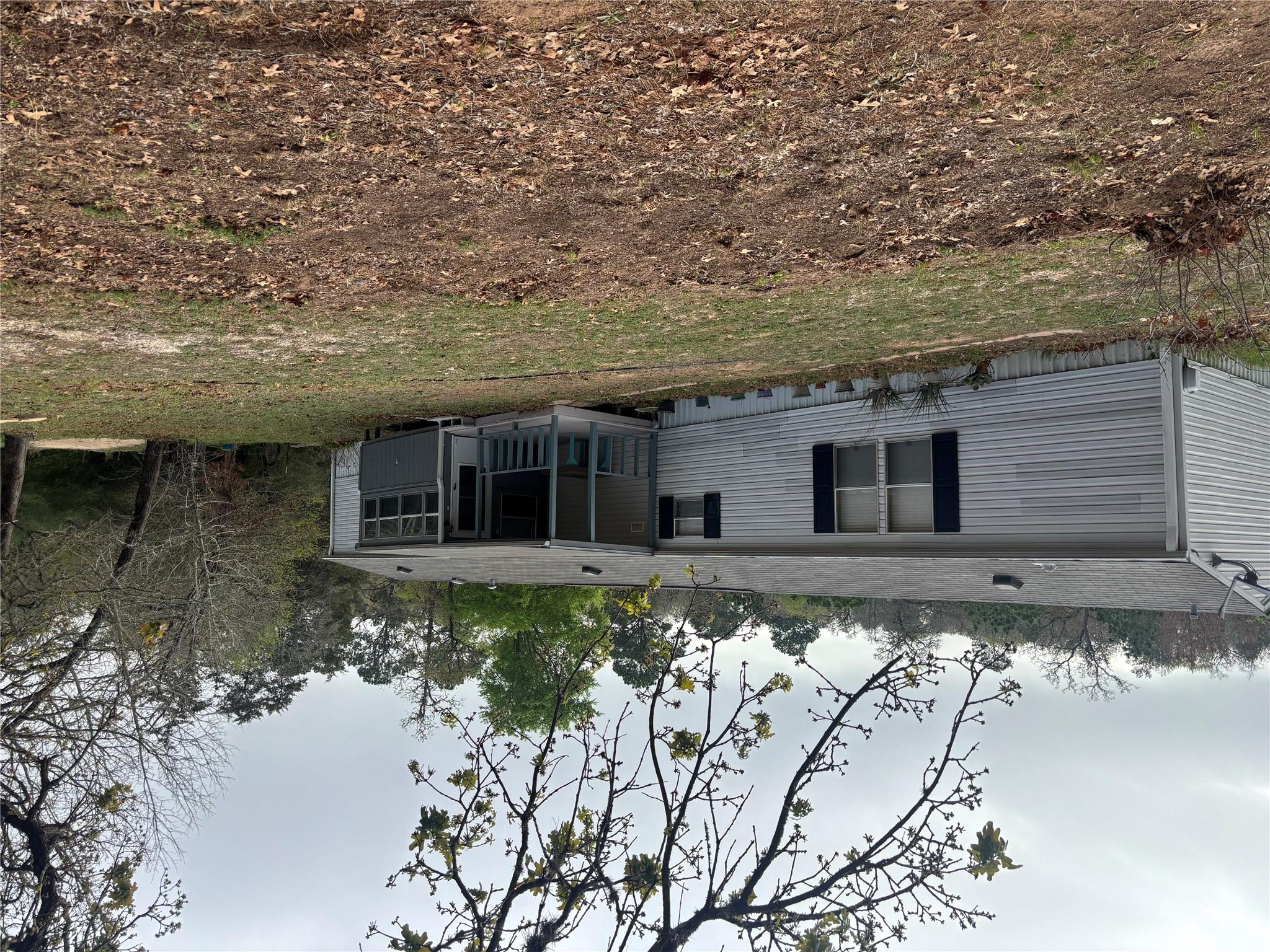 Back of house with a yard