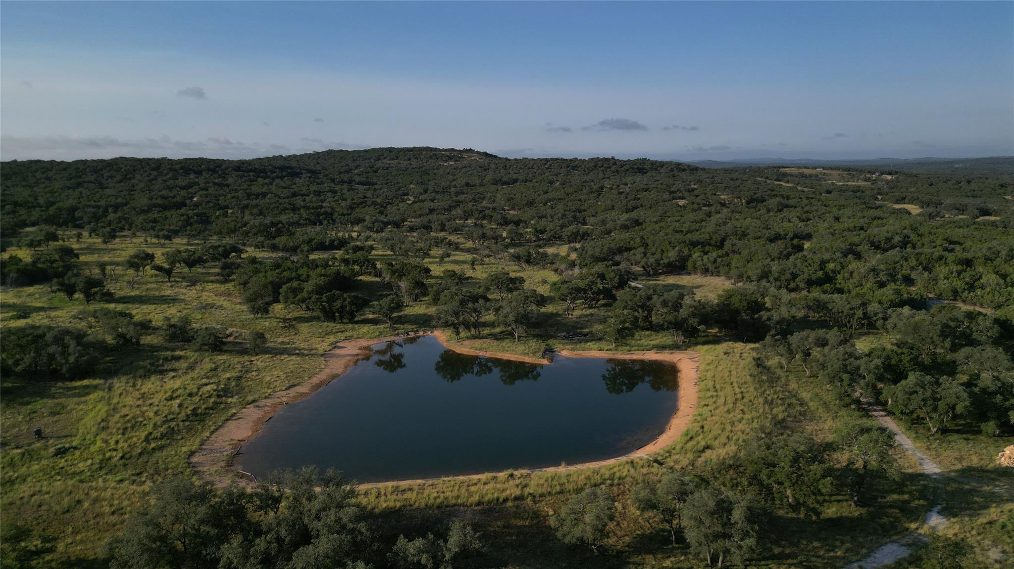 Aerial view of a heavily wooded area and a large 