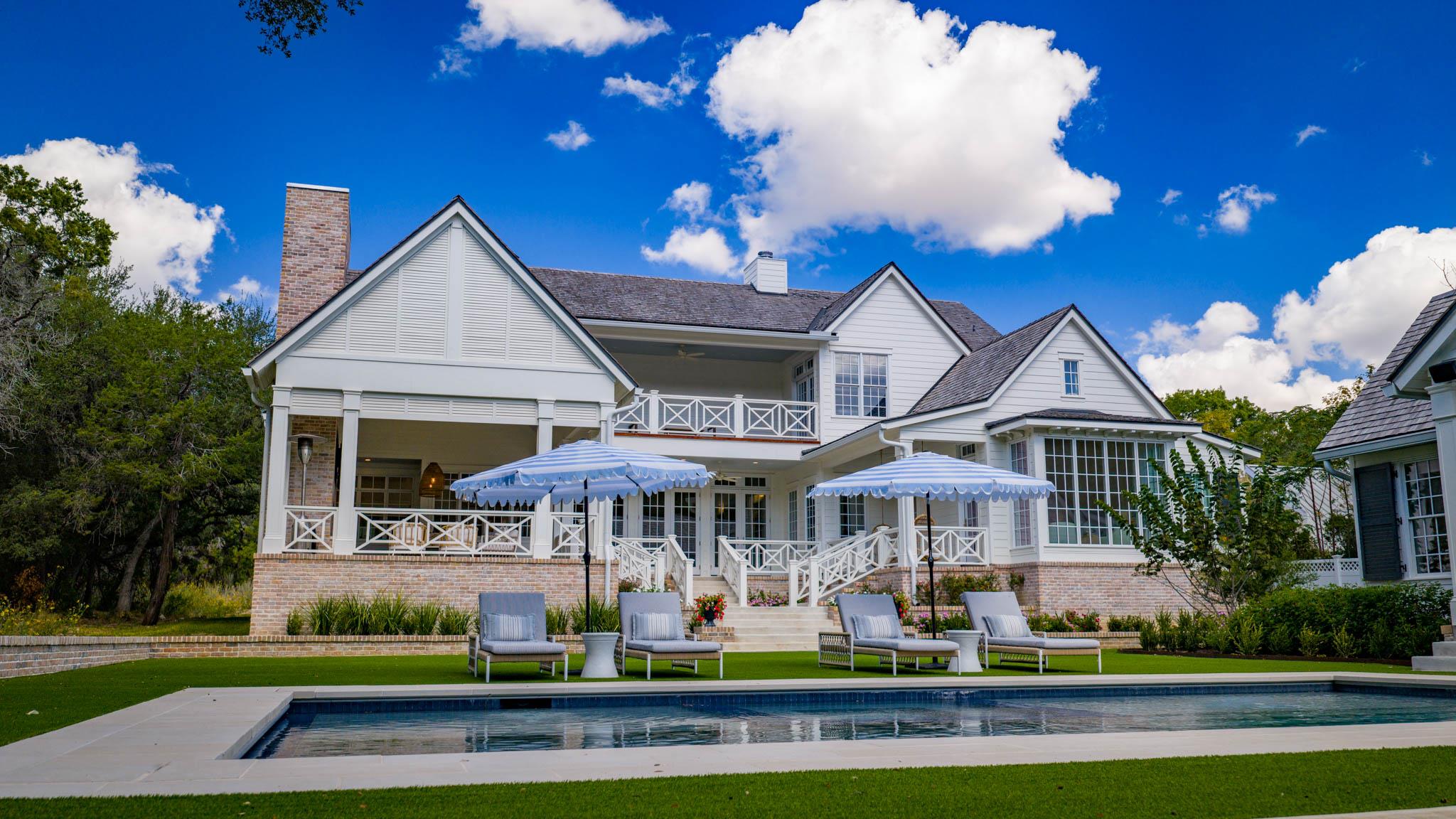 Back of house with a patio area, an outdoor pool,
