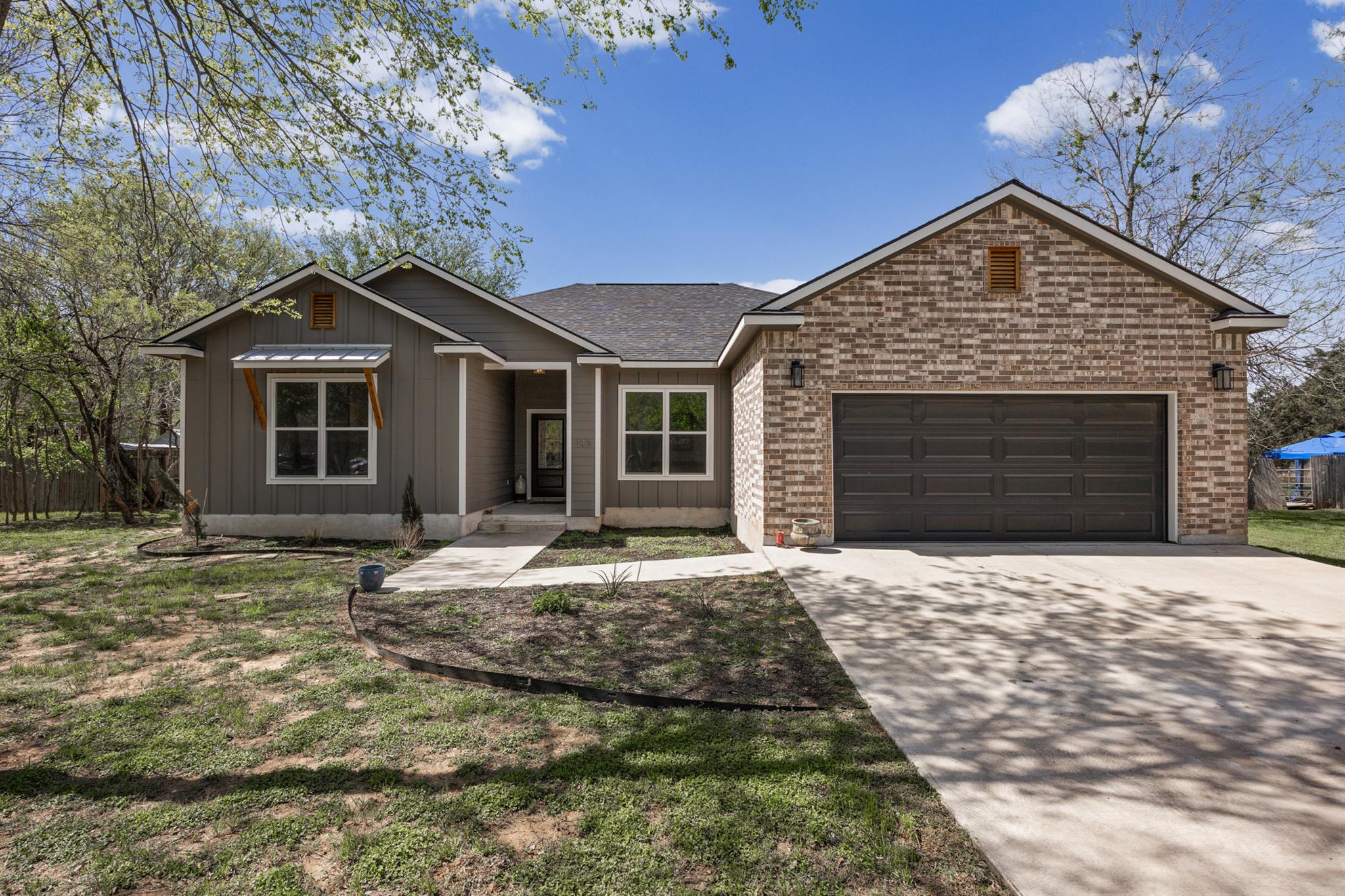 Ranch-style home with concrete driveway, a garage