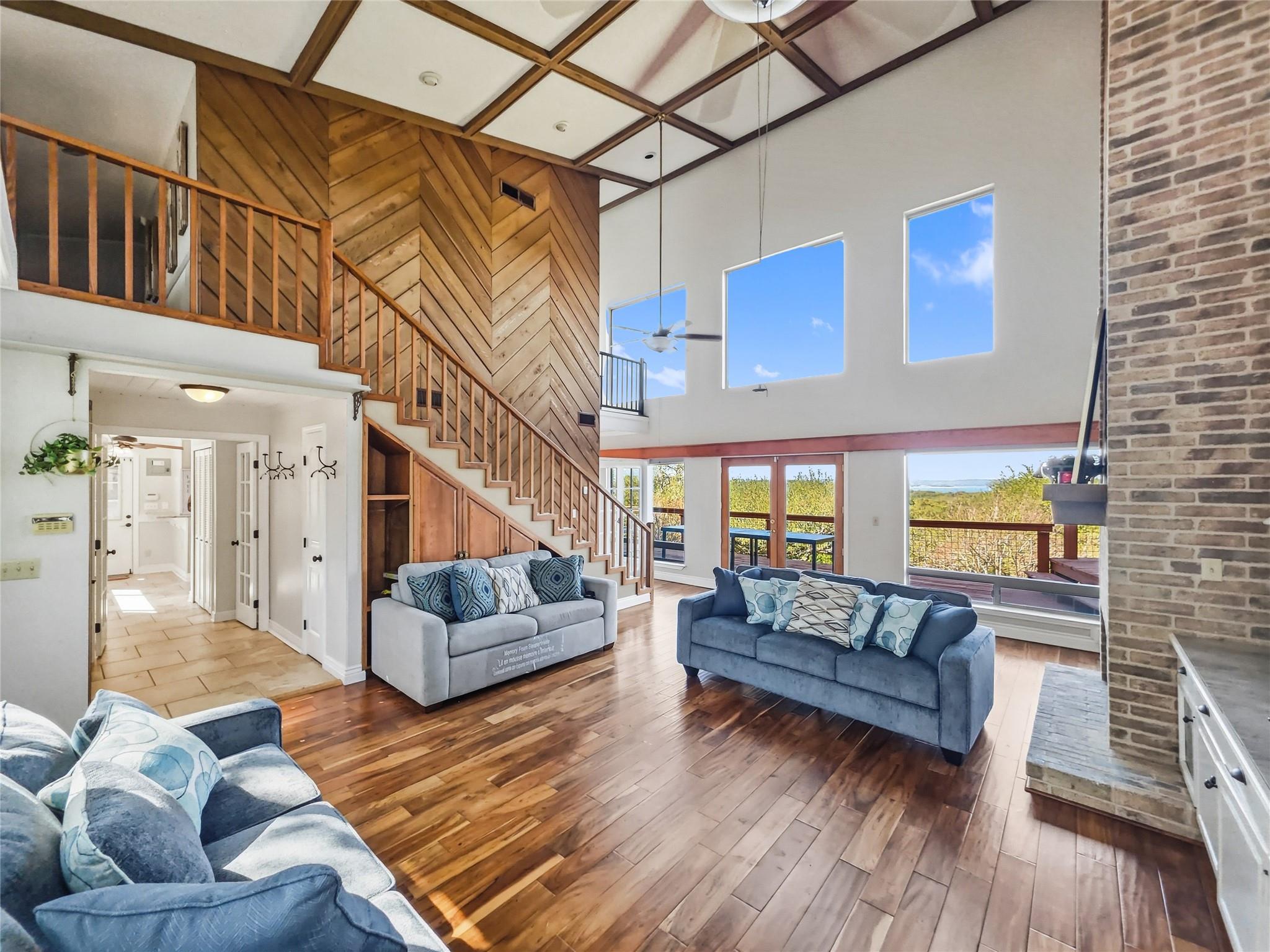 Living room with a high ceiling, hardwood / wood-