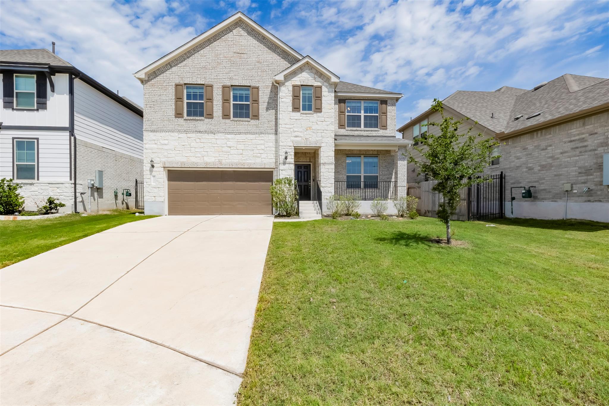 Stone and brick facade with a two-car garage