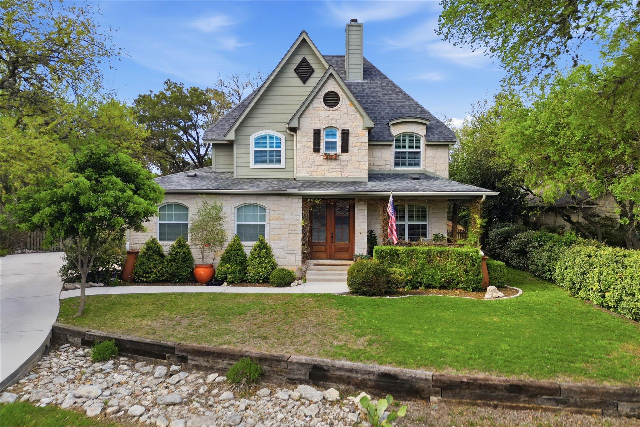 This grand residence showcases a charming stone a