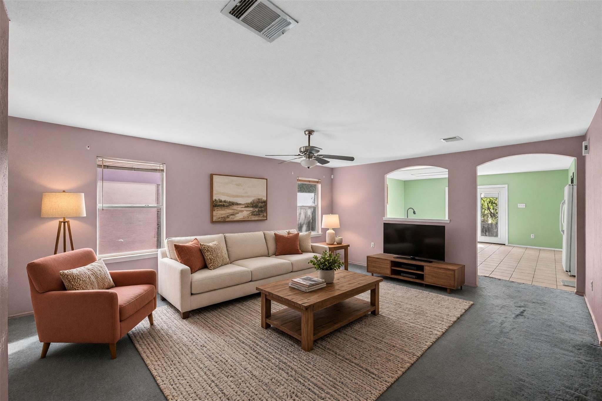 A comfortable living space boasts a ceiling fan, 