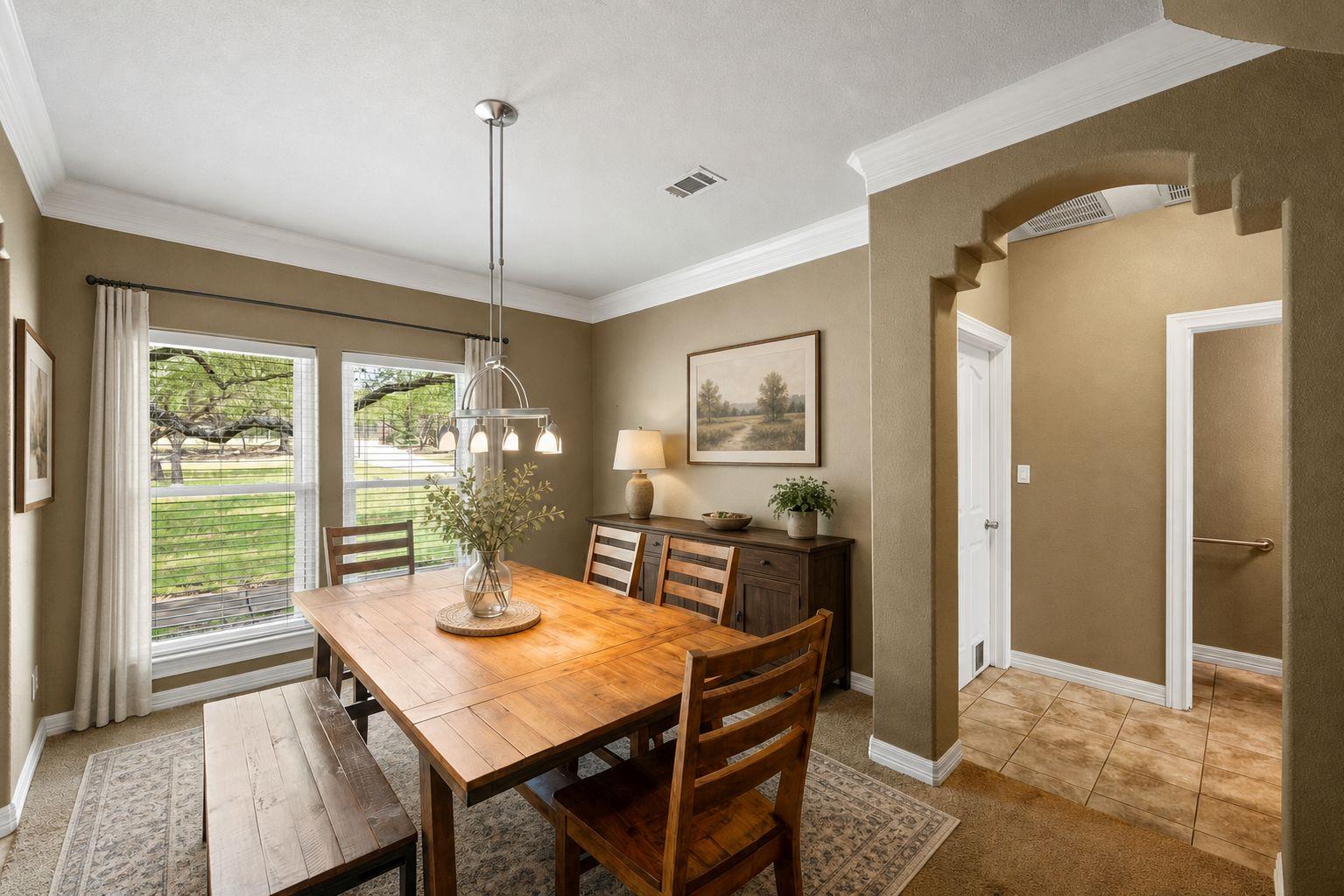 Well-appointed dining room featuring crown moldin