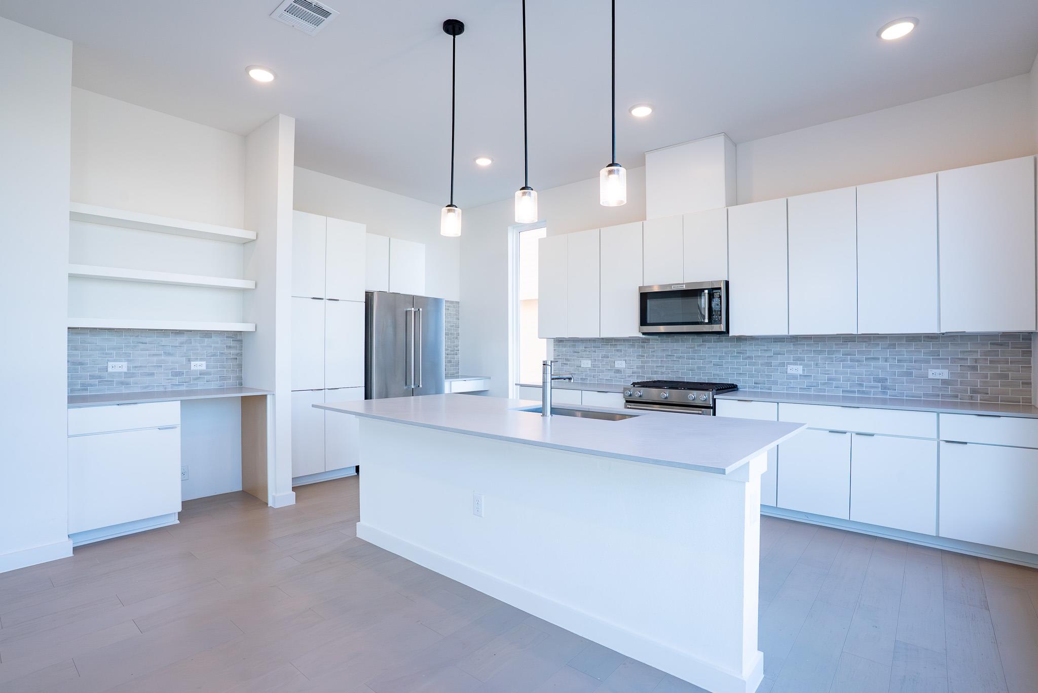 Kitchen featuring stainless steel appliances, mod