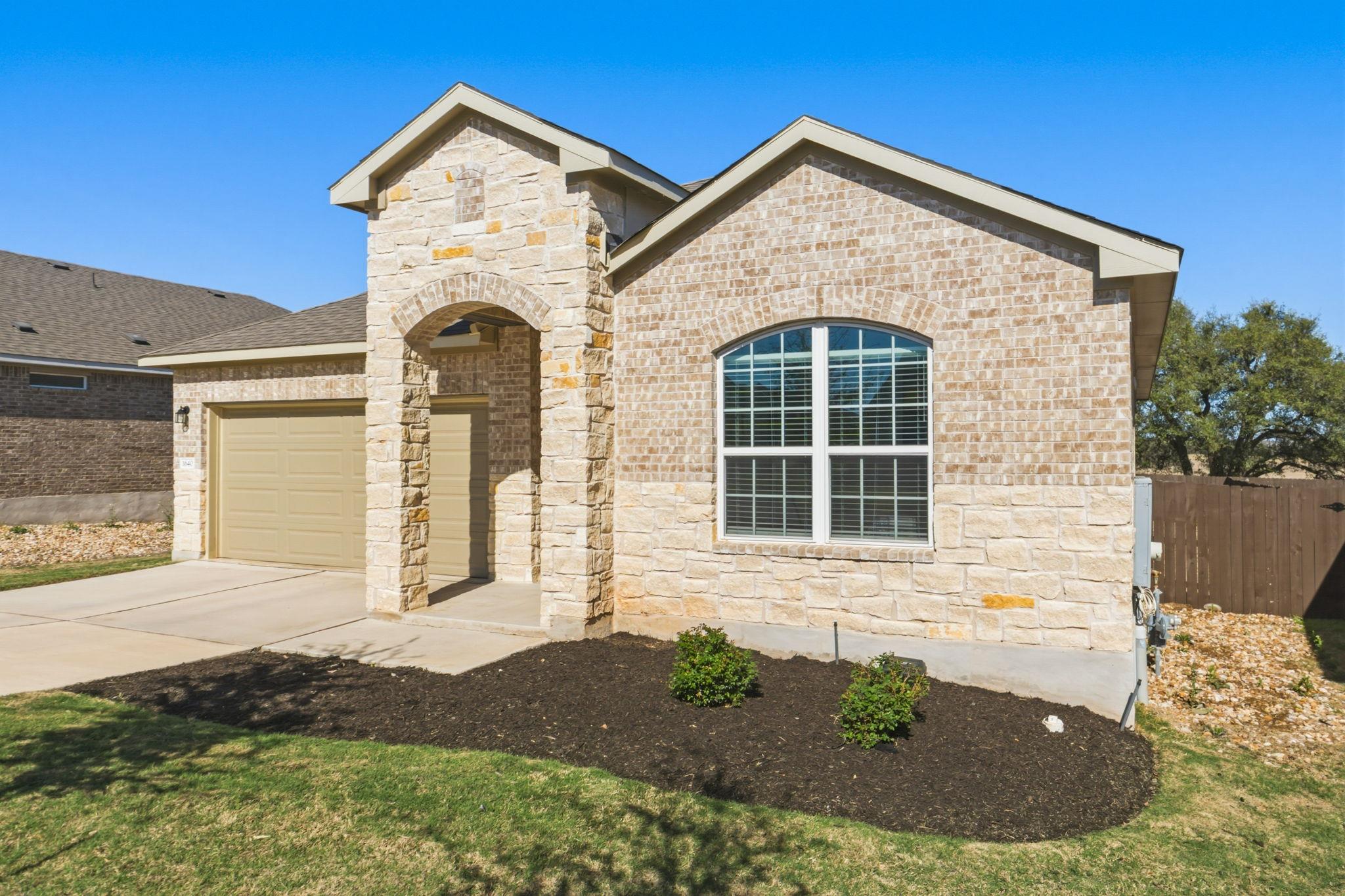 View of front facade featuring stone siding, bric