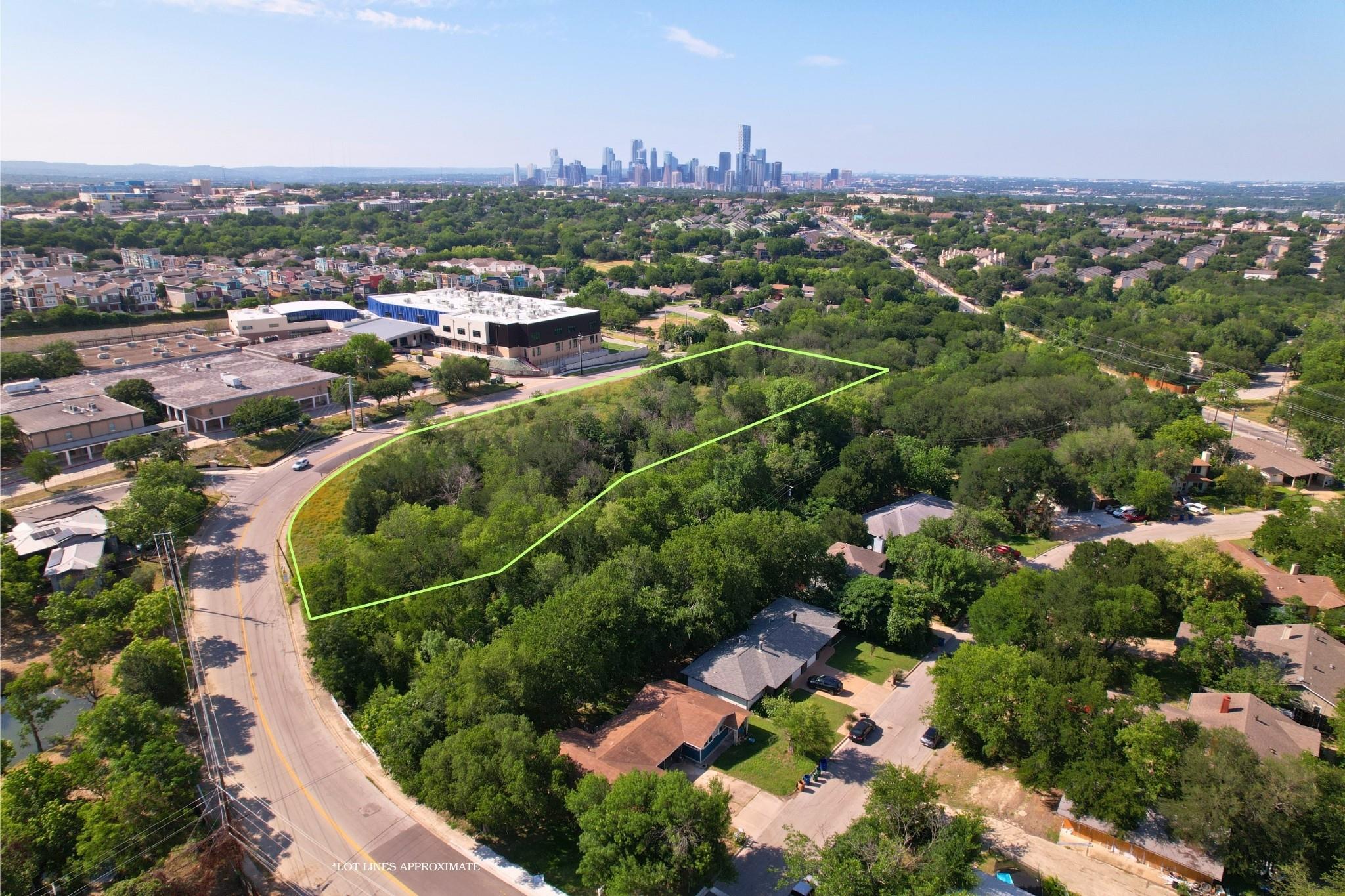 An aerial panorama reveals a vast, tree-filled lo