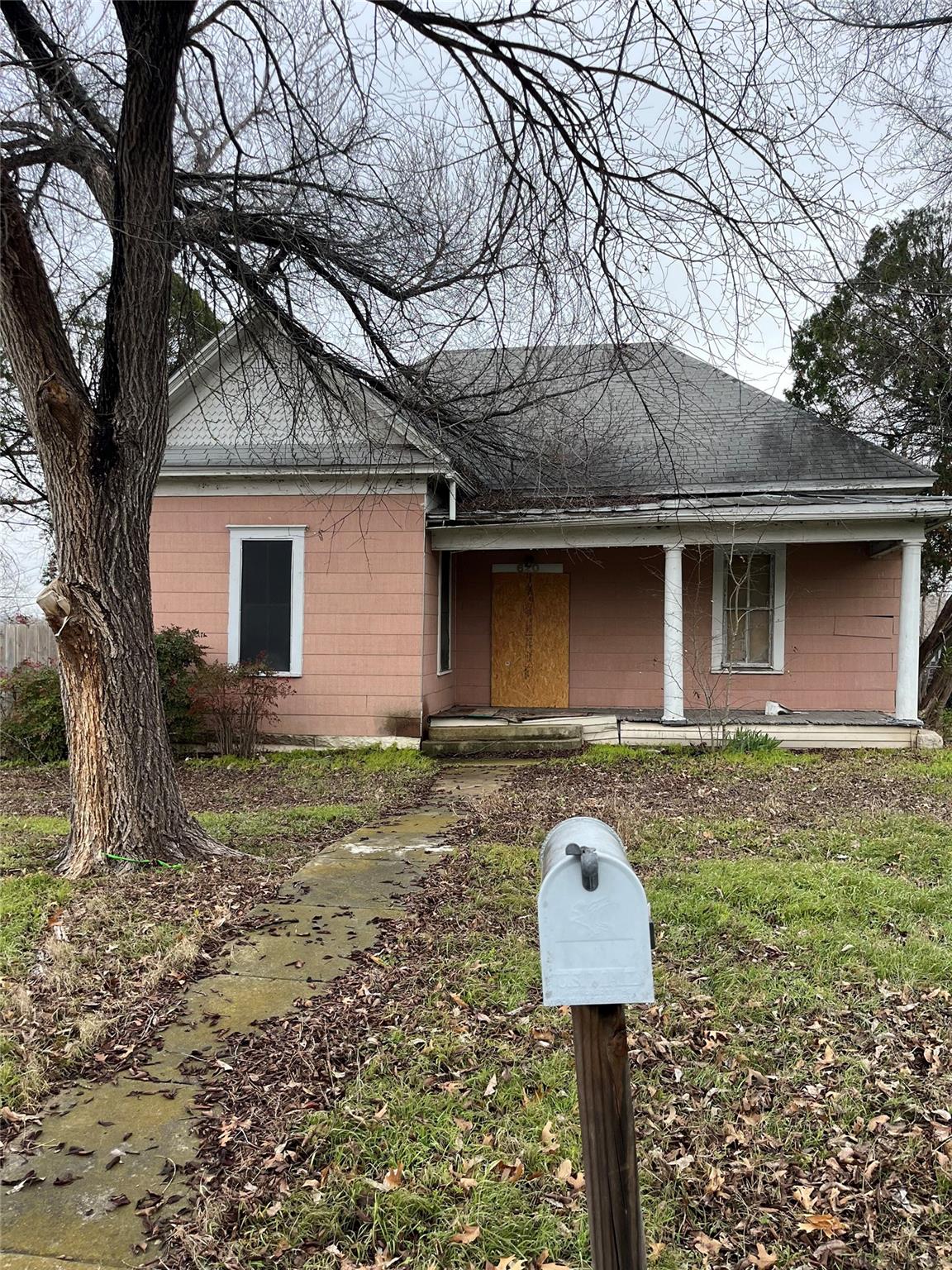 View of front of property with a shingled roof an