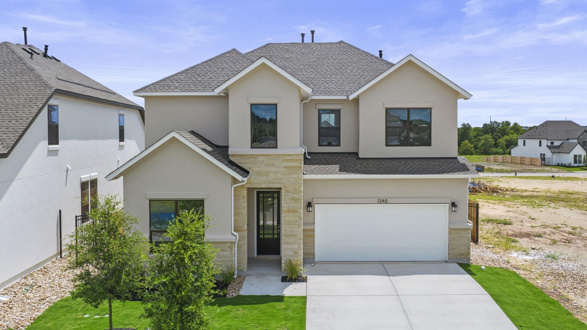 A newly constructed residence boasts a stucco and