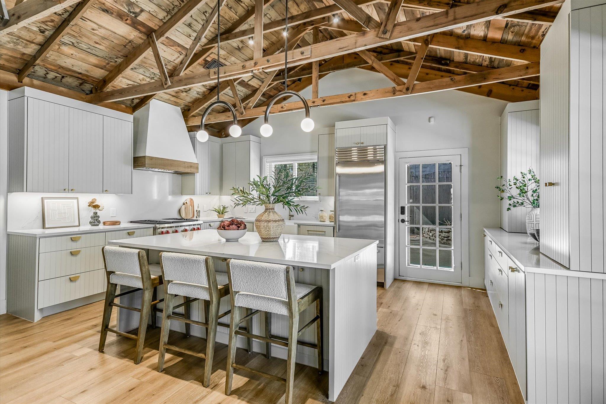 Kitchen featuring a high wood beamed ceiling, a k