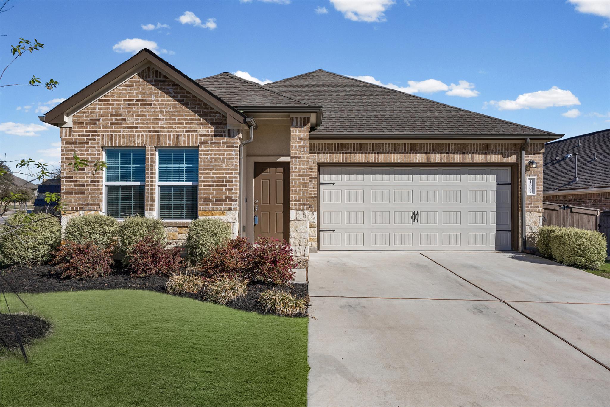 View of front of house with an attached garage, a