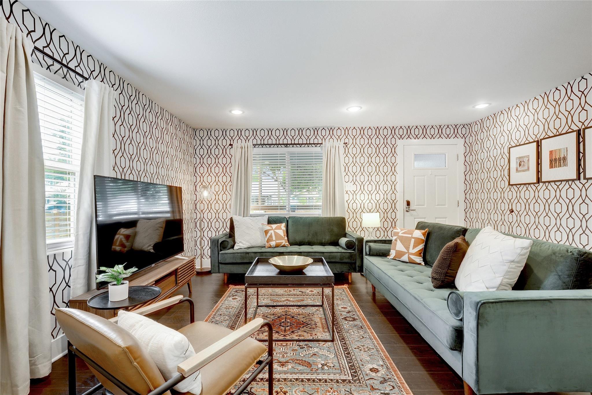 Living area with wallpapered walls, dark wood-sty