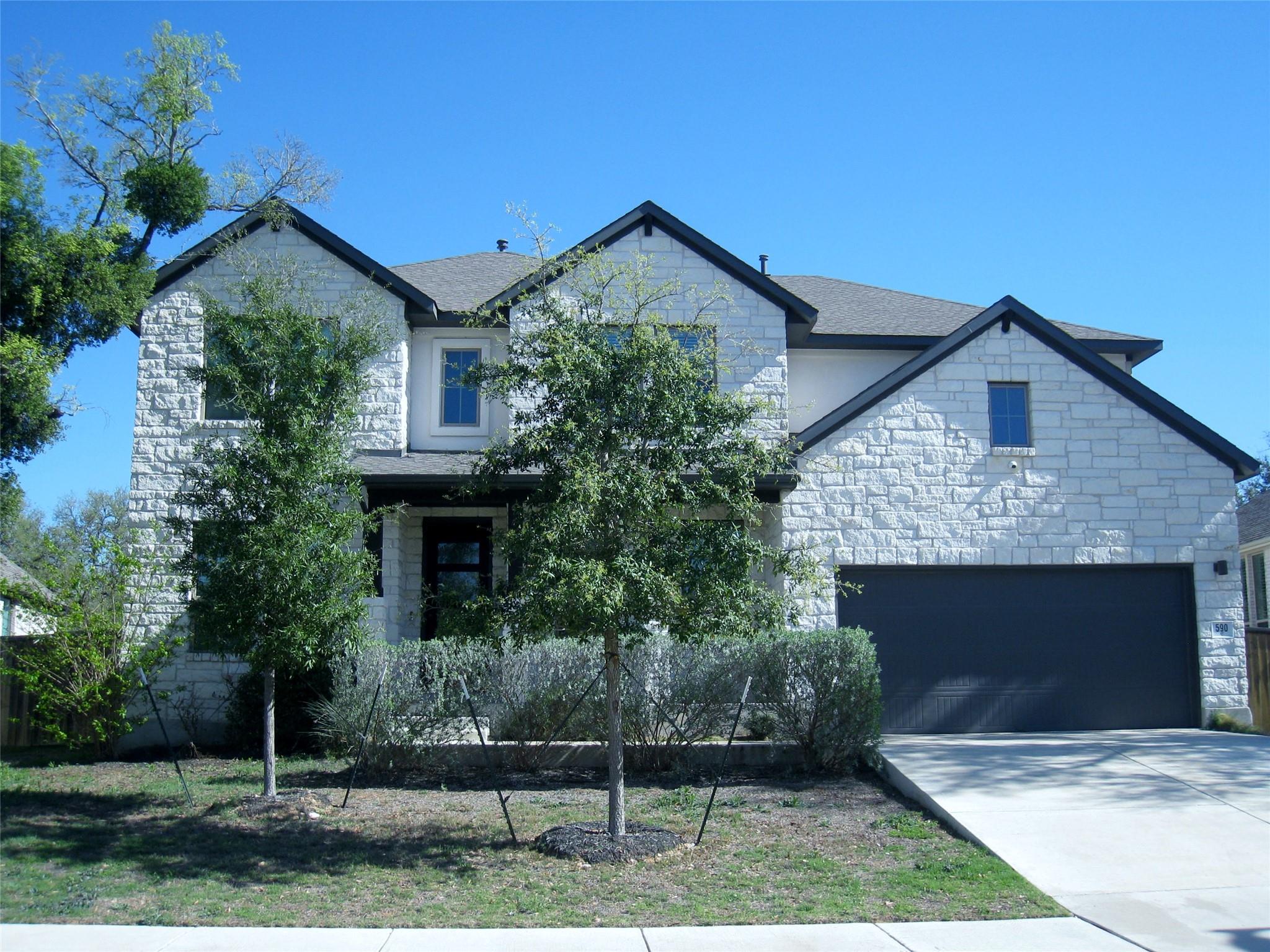View of front of property with stone siding, conc
