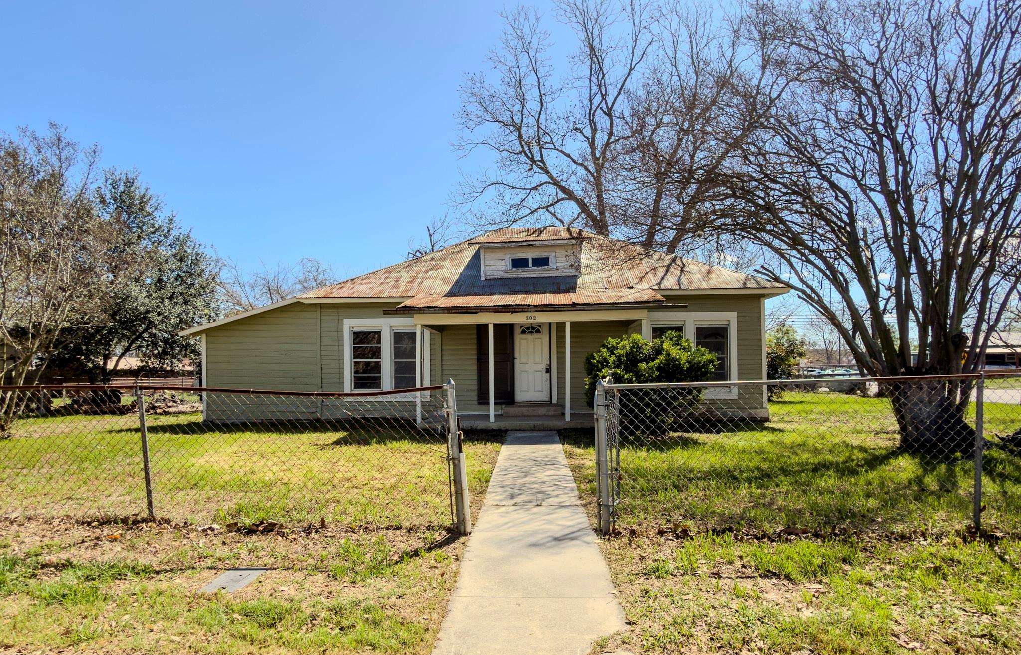 Bungalow-style house with a porch, a fenced front