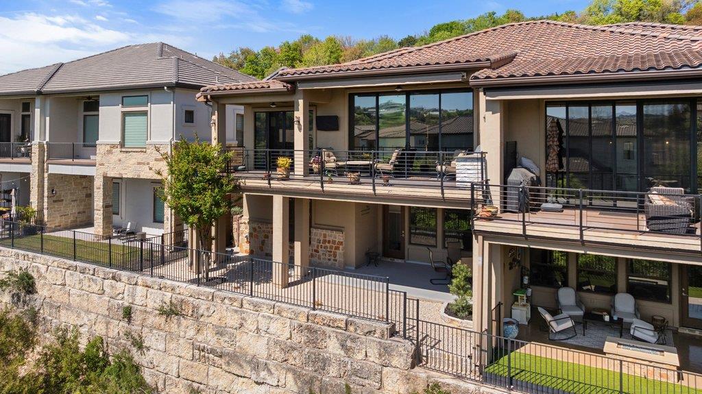 Back of house featuring a fenced backyard, a pati