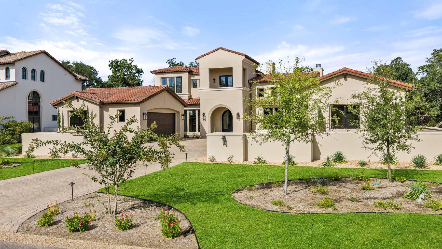 Spanish tile roofing and smooth stucco walls defi
