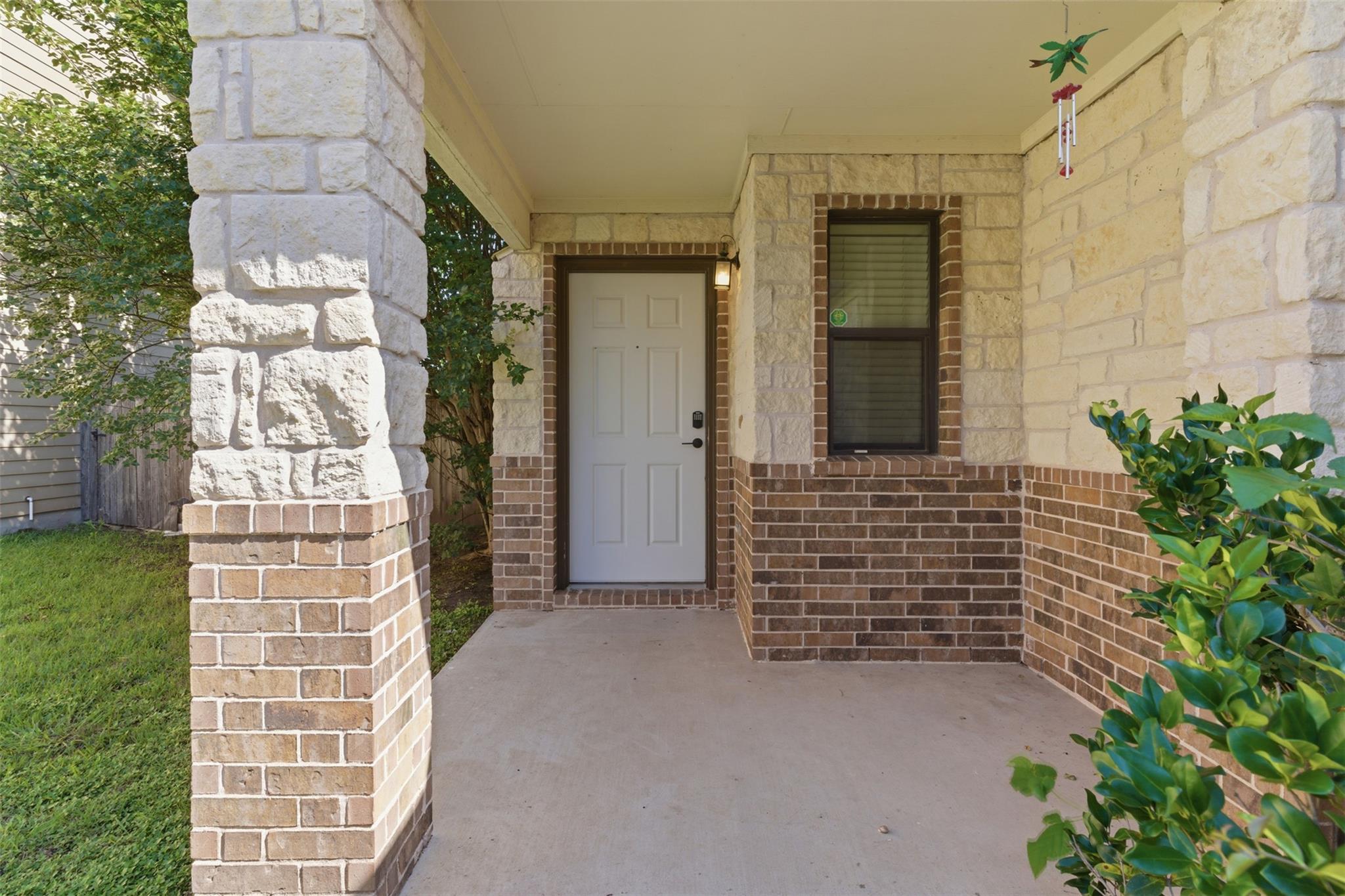 A welcoming front entry features sturdy brick and