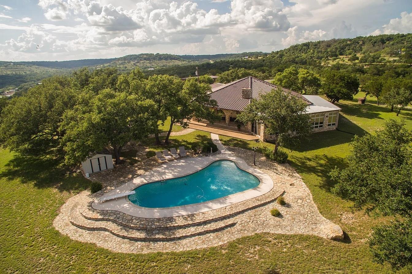 View of subject property featuring a pool area