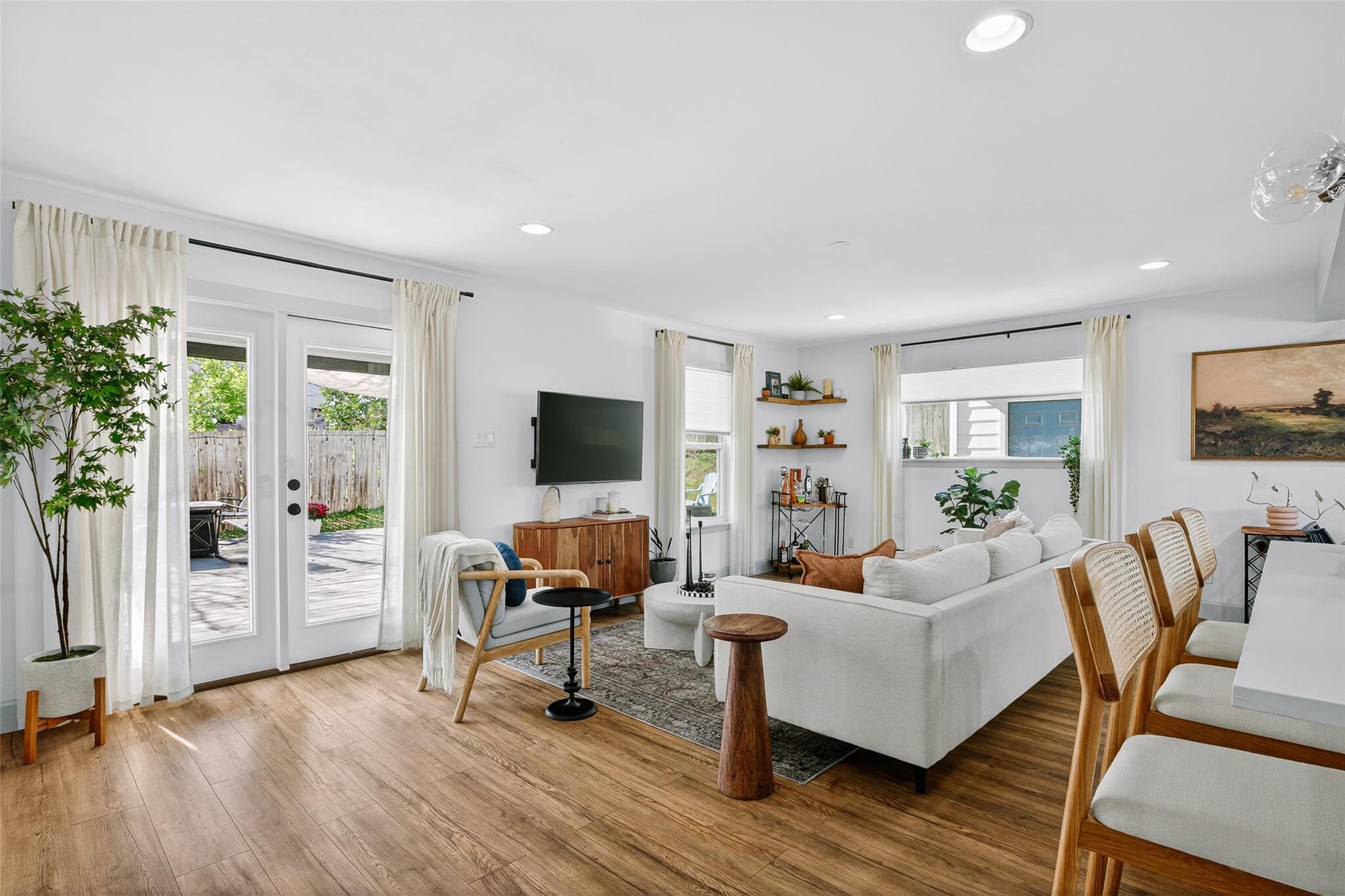 Living area with light wood-style flooring, frenc