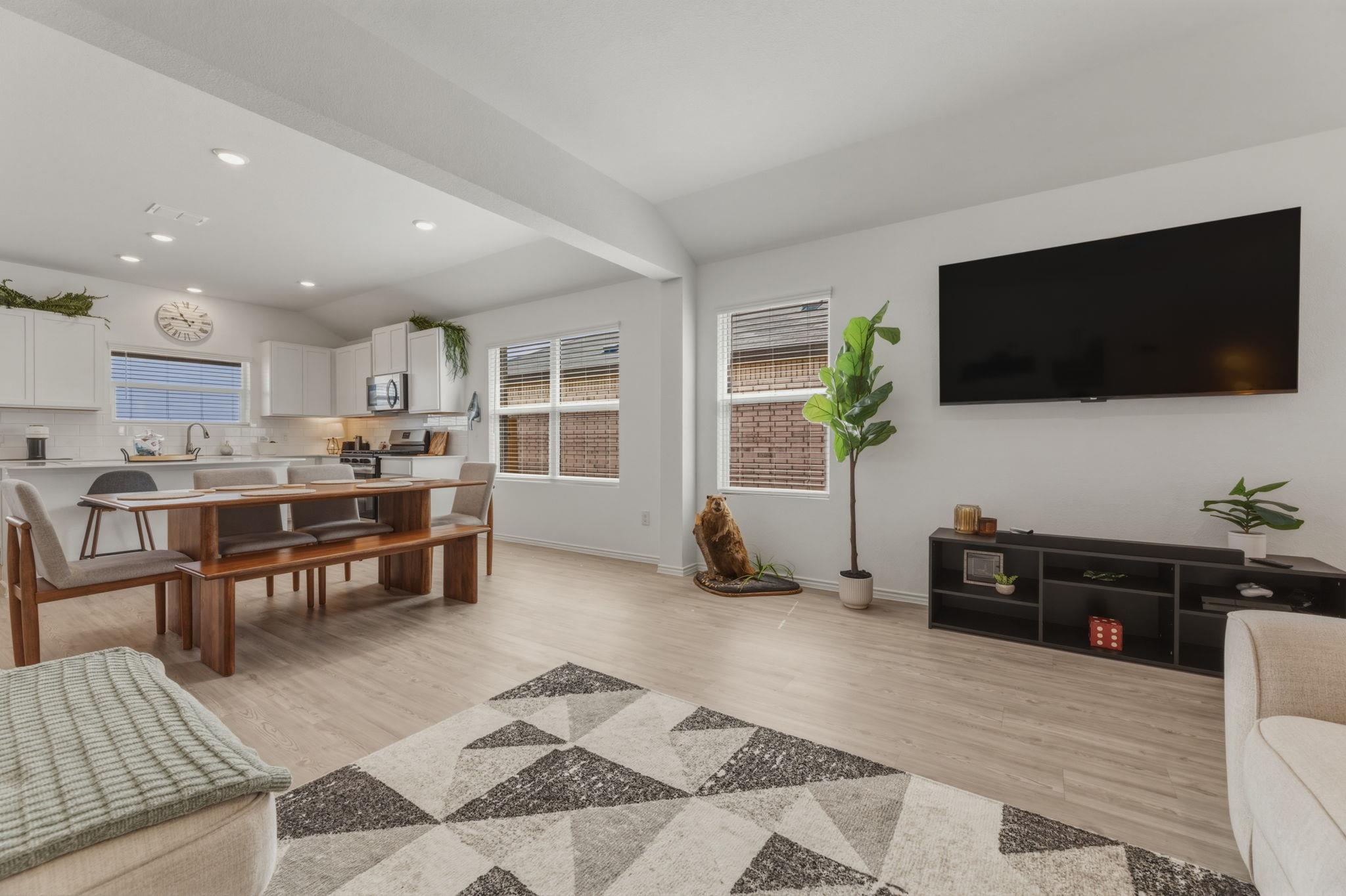 Expansive open-concept living area featuring ligh
