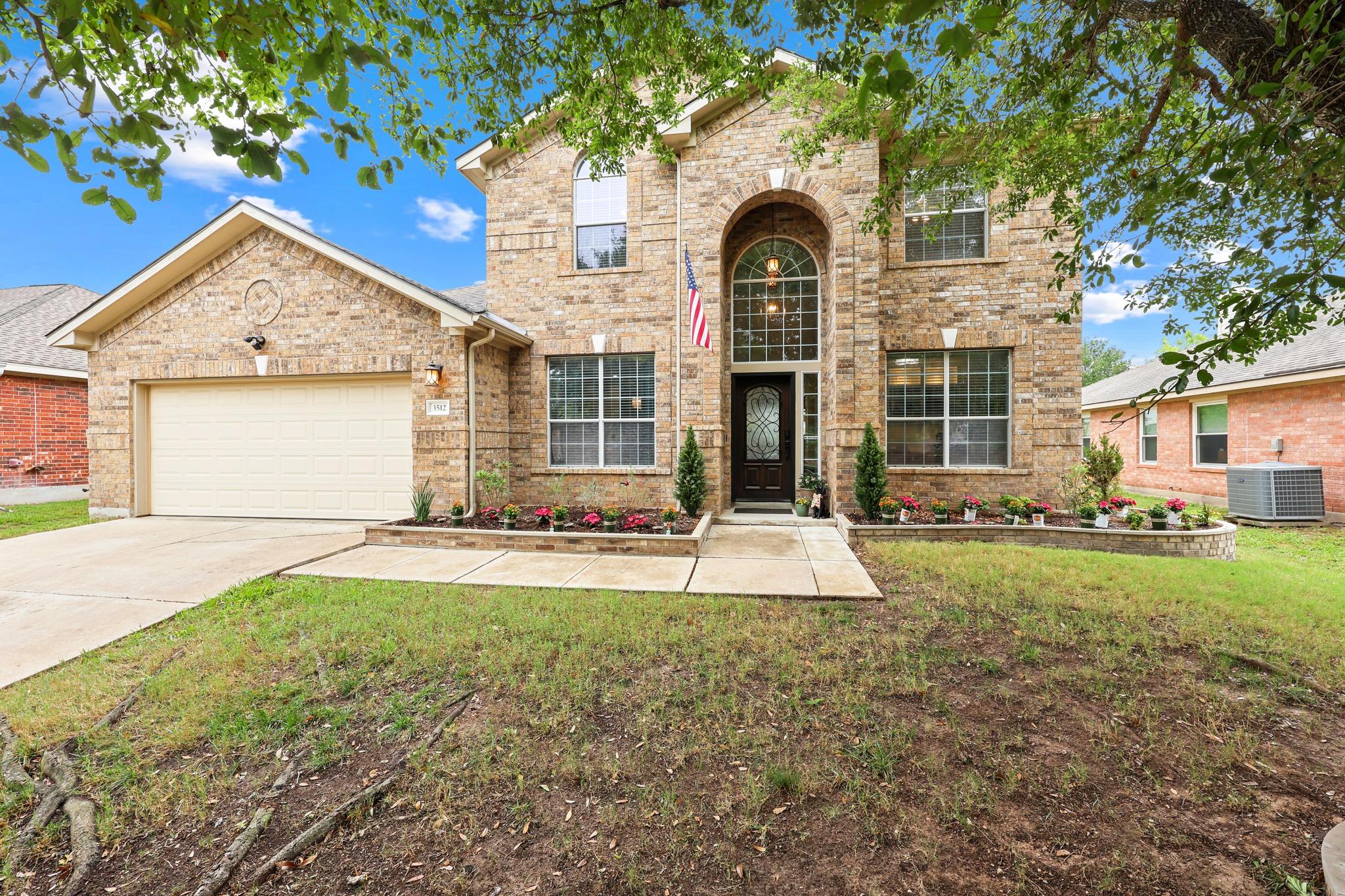 Two-story brick façade featuring an arched entry,