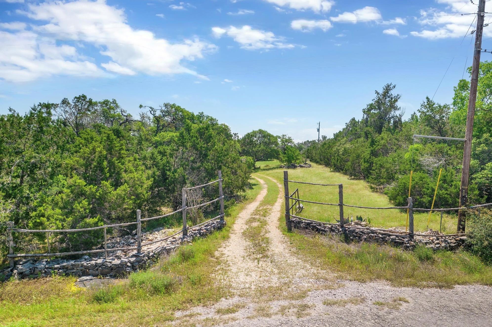 A private, rustic entry leads to a verdant, spraw