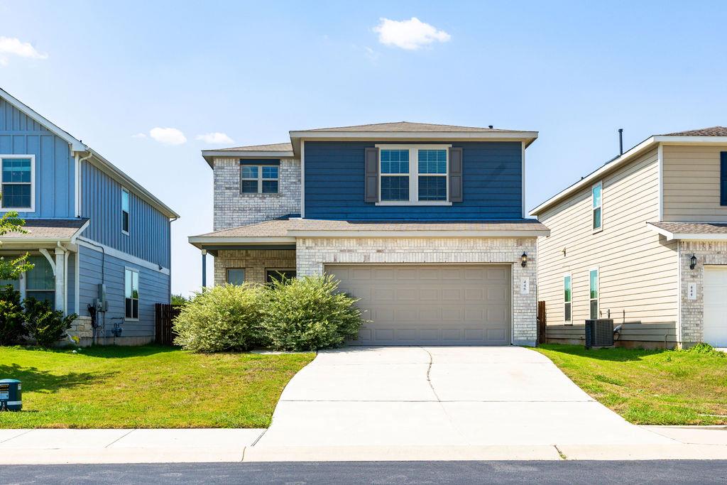 A well-maintained two-story residence with a pave