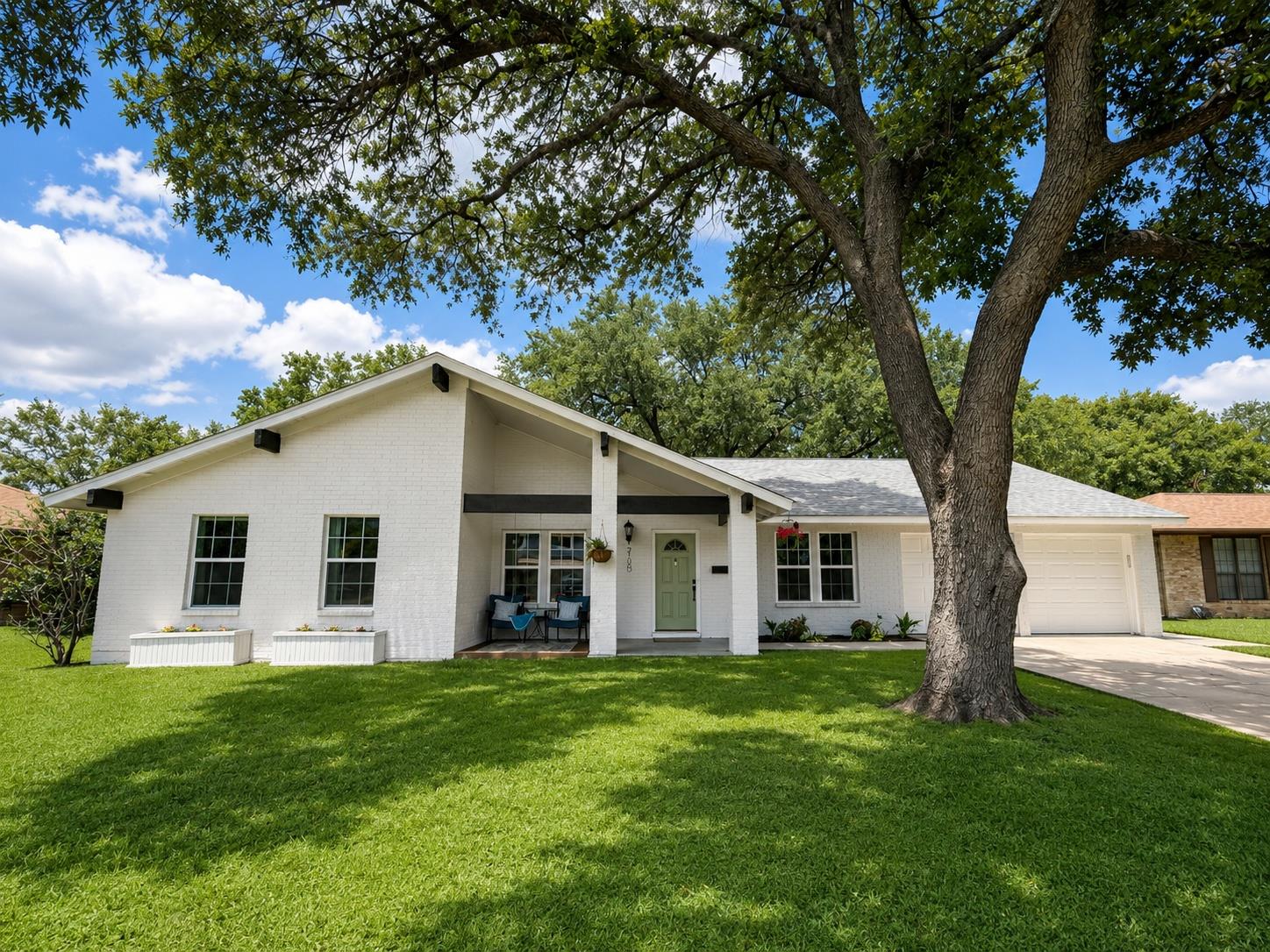 Well-maintained front lawn welcomes you to this c