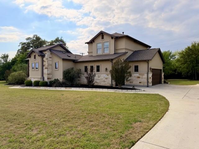 A spacious home with stone accents and a long dri