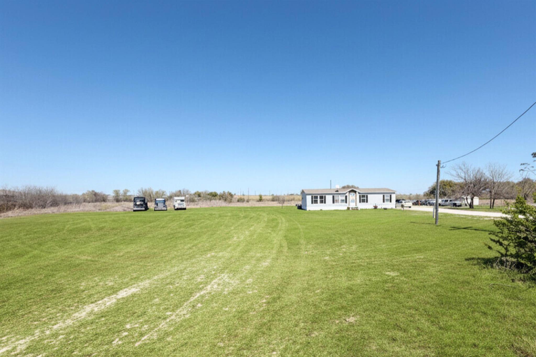 View of grassy yard with a rural view