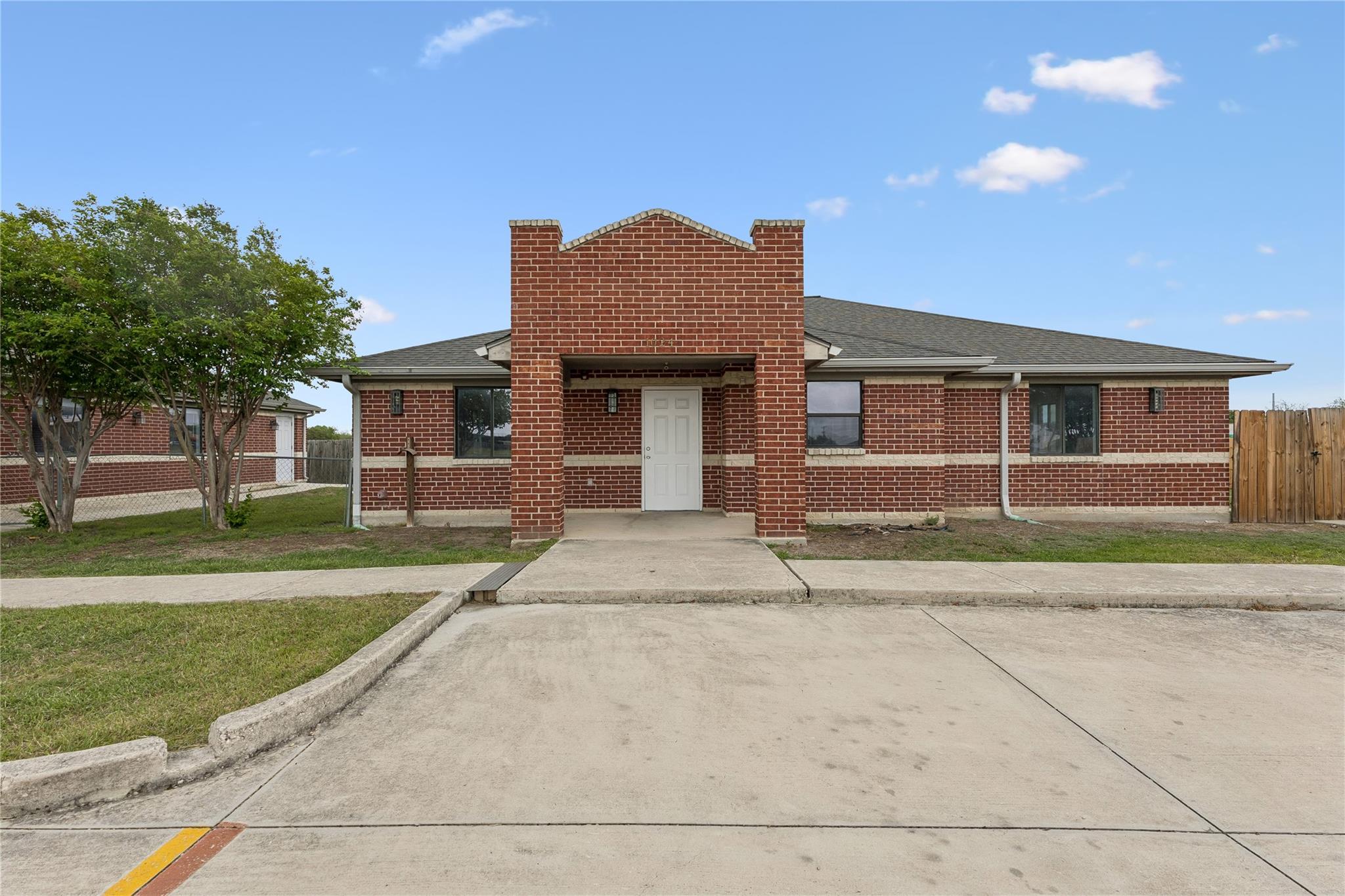 View of front of house with brick siding and roof
