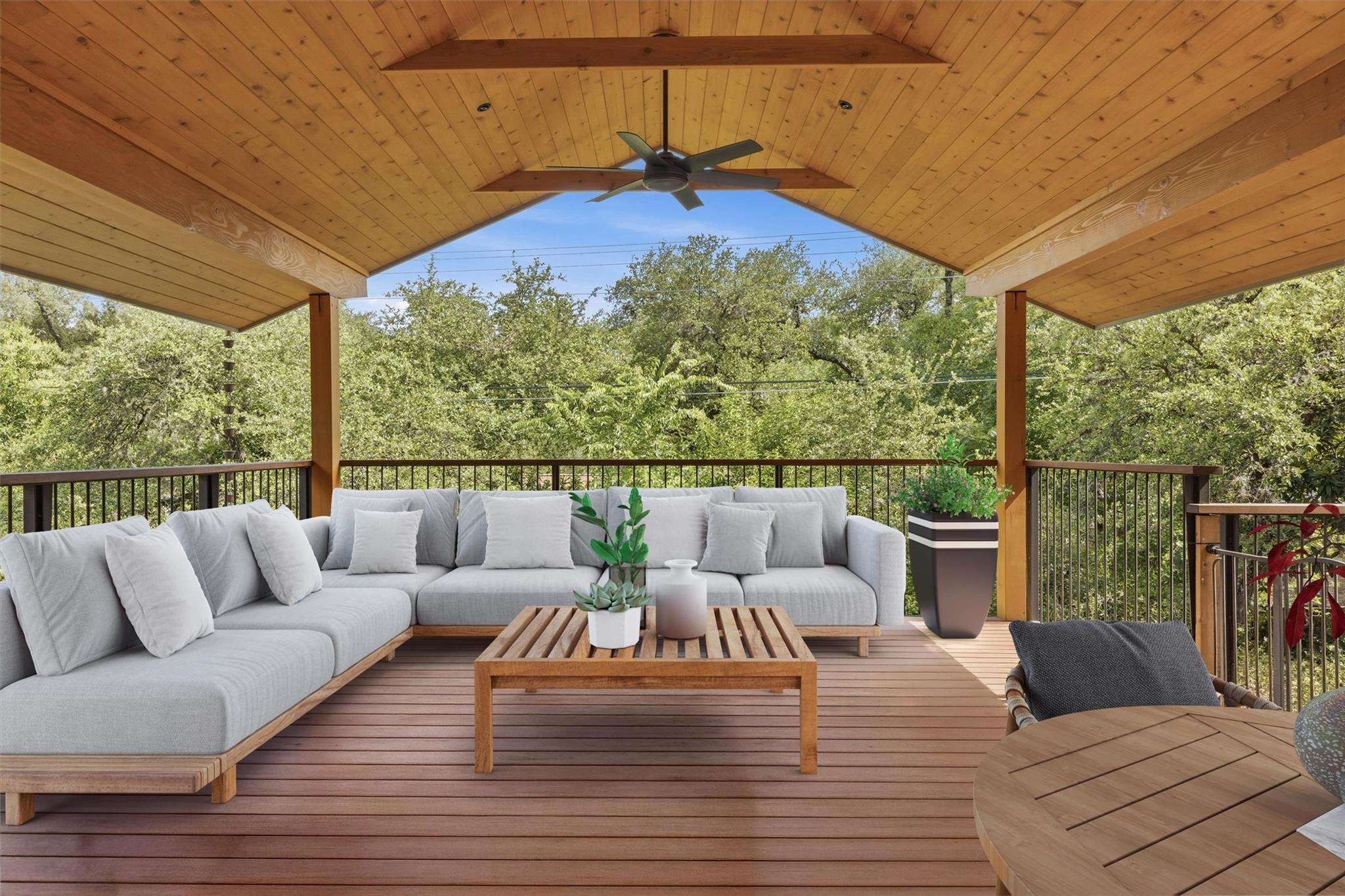 An inviting covered deck with exposed wood beams 