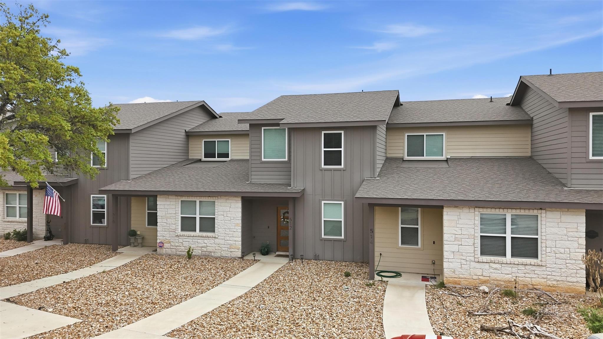 Traditional-style home with stone siding, a shing
