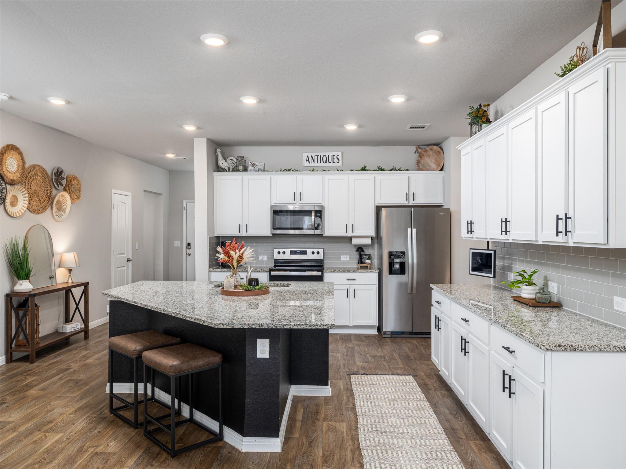 Kitchen with stainless steel appliances, light st
