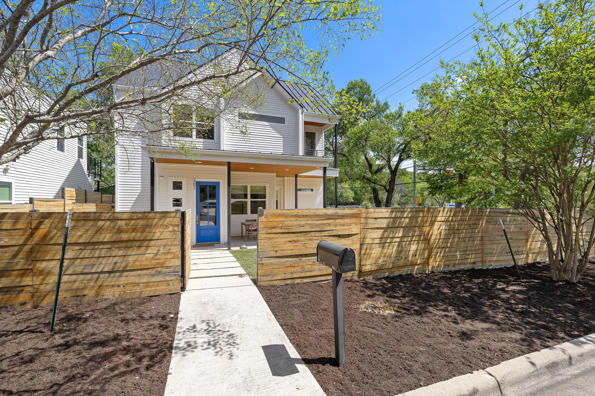 Traditional-style house with a fenced front yard,
