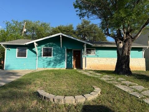 Single story home featuring a front yard